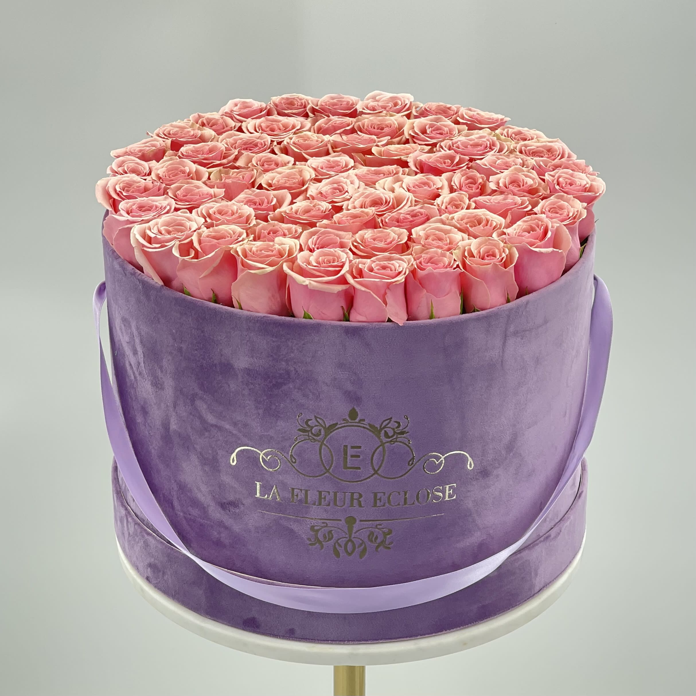 As Lovely as you V - 70 fresh light pink roses on our Lavander velvet signature box