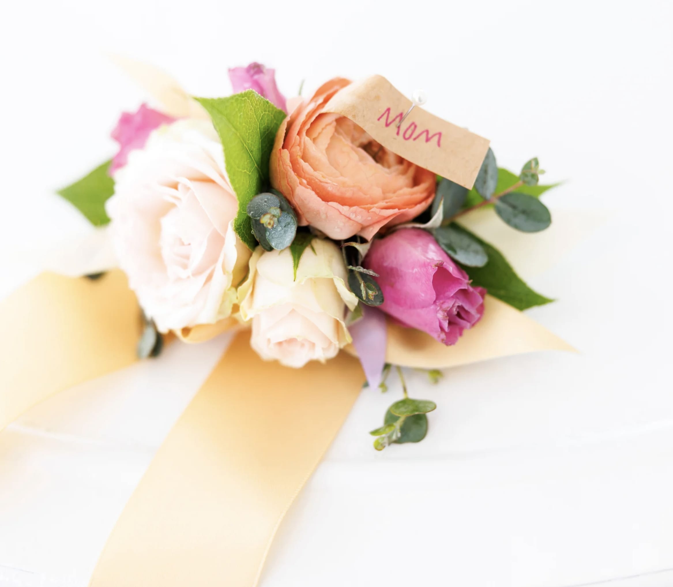 Corsage - Elevate your look with an exquisite corsage, thoughtfully designed with fresh, hand-selected blooms and delicate accents. Perfect for weddings, proms, or special events, this wearable floral piece adds a touch of sophistication and charm to any ensemble.  