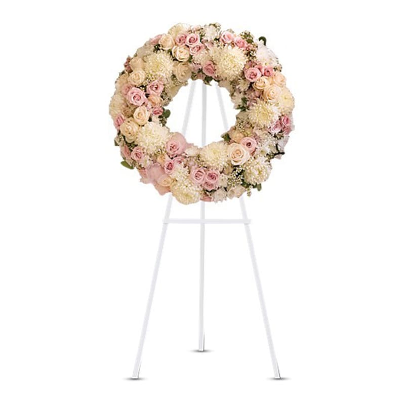 Peace Eternal Wreath - A breathtaking expression of love and devotion this lovely wreath delivers a message that is both subtle and strong. Its soft pastel blossoms will soothe while its extraordinary beauty will express the depth of your emotions.  Gorgeous pink hydrangea, crème roses, light pink spray roses, white chrysanthemums, waxflower and more are adorned by pink organza ribbon in this eternal circle of peace.  Approximately 24 1/2&quot; W x 24 1/2&quot; H Orientation: One-Sided