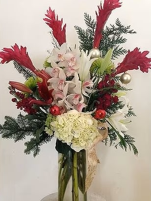 Winter Wonderland - This stunning arrangement, with its elegant combination of white orchids, red lilies, festive berries, and lush evergreen foliage, is a perfect reflection of the winter season. The addition of decorative silver and red ornaments gives it a festive, holiday-themed look, making it an ideal centerpiece for Christmas celebrations. The mix of fresh greens and delicate flowers creates a balance of warmth and elegance, perfect for spreading holiday cheer. This bouquet evokes the magic of a snowy winter morning, making it suitable for a wide range of occasions, especially during the holiday season. _________________ Flower Features: • White Orchids: Symbolize beauty, grace, and elegance. • Red Lilies: Represent passion and festive spirit. • Evergreen Foliage: Adds a natural, wintery touch, symbolizing endurance and strength. • Berries and Ornam __________________ Perfect for These Occasions:  Christmas &amp; Holiday Celebrations: This arrangement is ideal for adding a festive touch to your home or as a gift to loved ones during the holiday season.  Corporate Gifts: A thoughtful and elegant gift for business partners or clients to celebrate the end of the year.  Winter Weddings: Perfect for winter-themed weddings as a centerpiece or bridal bouquet.  Housewarming Gifts: A lovely arrangement to brighten a new home, especially during the winter months.  Anniversaries: Celebrate a special moment with a bouquet that embodies grace and festive charm.