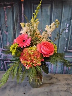 Winter Wonder Winter Wonder - This winter wonder floral arrangement is bold, beautiful and perfect for your holiday celebrations. Elements of coral, pink and winter greens adds a pop of color for a festive and fun holiday.