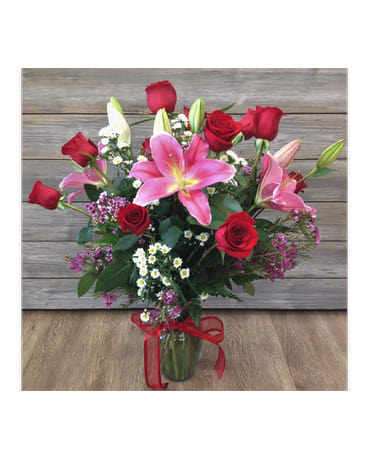 Red Roses With Lilies Red Roses With Lilies - A dozen red roses and stargazer lilies are everyone's favorite combination! Substitutions of flowers & containers depend on availability and season. If any large substitutions are to be made, we will contact you first. Please see the substitution policy on our home page in the 'About Us' section. FCF-469