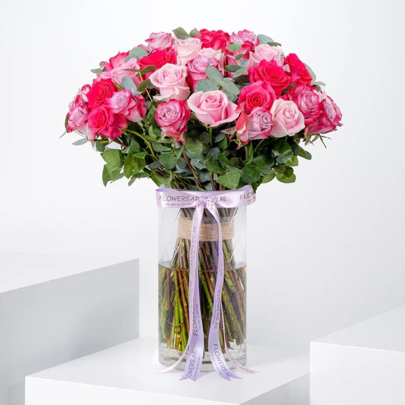 50 Blush Roses Vase 50 Blush Roses Vase - 50 blush roses— a stunning mix of fuchsia, pink, and purple in a vase, perfect for Valentine’s Day.