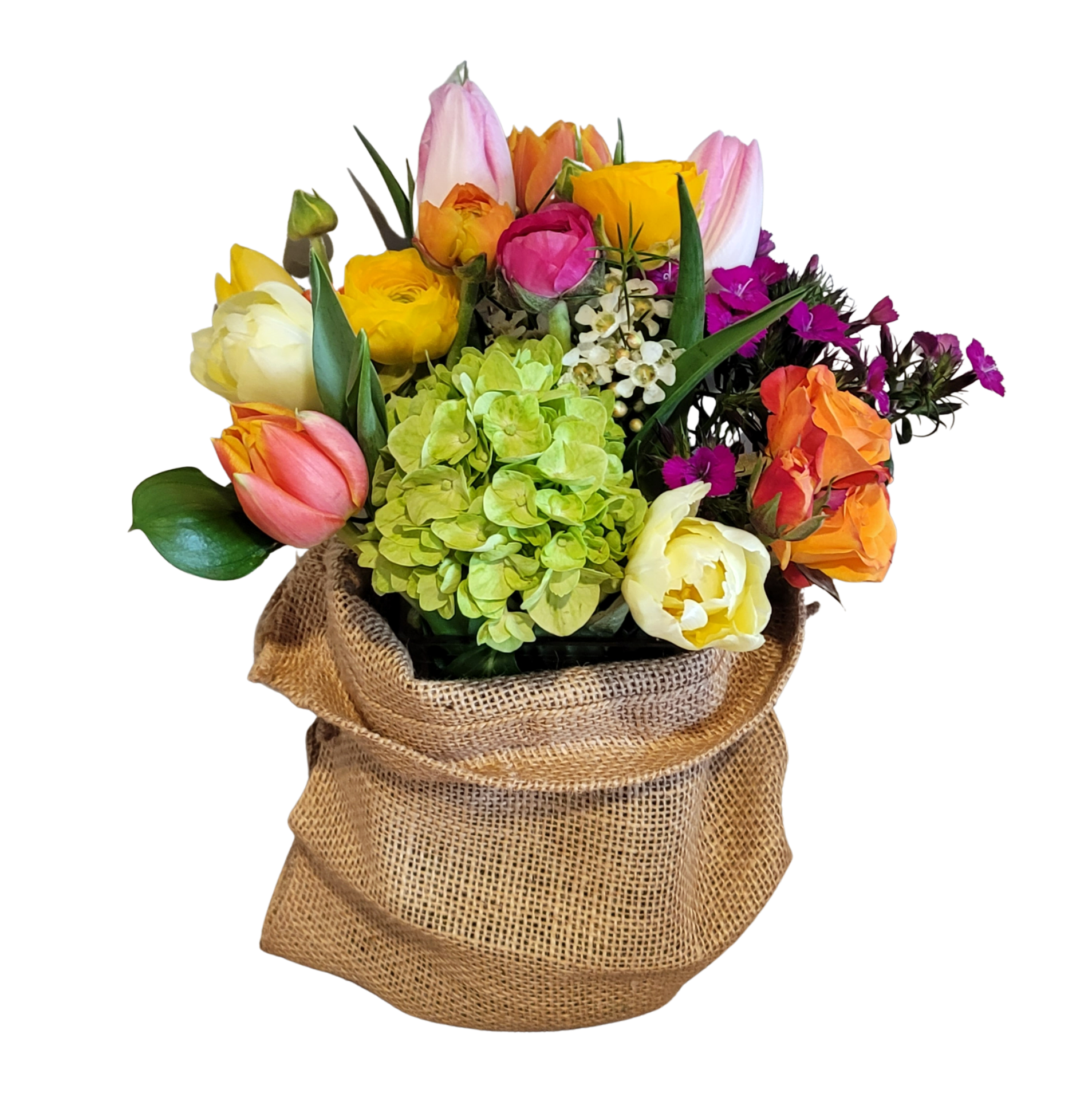 Spring Market in Burlap - A spring arrangement in a glass vase. with a burlap sack with seasonal spring flowers. This will have a happy spring feeling but some of the flowers may Vary. 