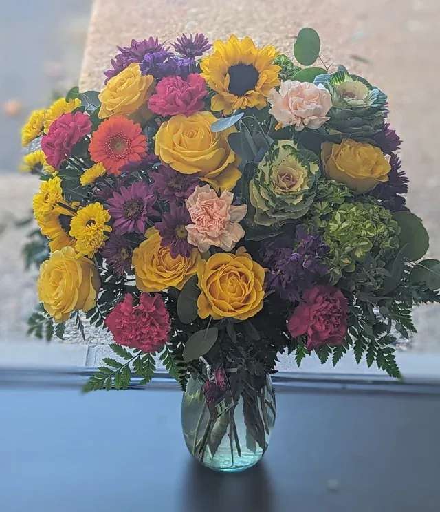 XL Vase Arrangement- Jewel Tone XL Vase Arrangement- Jewel Tone - Make a big impression for that person who loves rich jewel tones and bold elegance! This arrangement offers a big statement by sharing the best in deep purples, sunny yellows, hot pinks and warm and cool oranges. Sending this arrangement will ensure the recipient never forgets you or the moment you are commemorating.