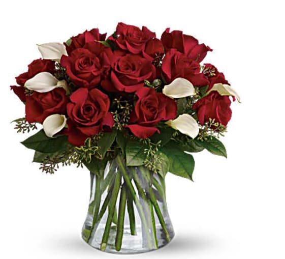 My Fair Lady - Dozen Red Roses with Calla Lillies My Fair Lady - Dozen Red Roses with Calla Lillies - Who's the fairest of them all? Elegant callas, without a doubt. This graceful arrangement is accented with calla lilies in a glass vase for a modern, romantic arrangement.