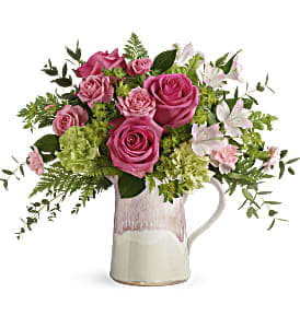 Teleflora's Heart Stone Bouquet Teleflora's Heart Stone Bouquet - Win her heart this Mother's Day with this chic stoneware pitcher! Shimmering with a glorious iridescent reactive glaze, this food-safe favorite is a gift in and of itself. Filled with a chic bouquet of hydrangea and roses, it's a lavish surprise she'll remember forever!
