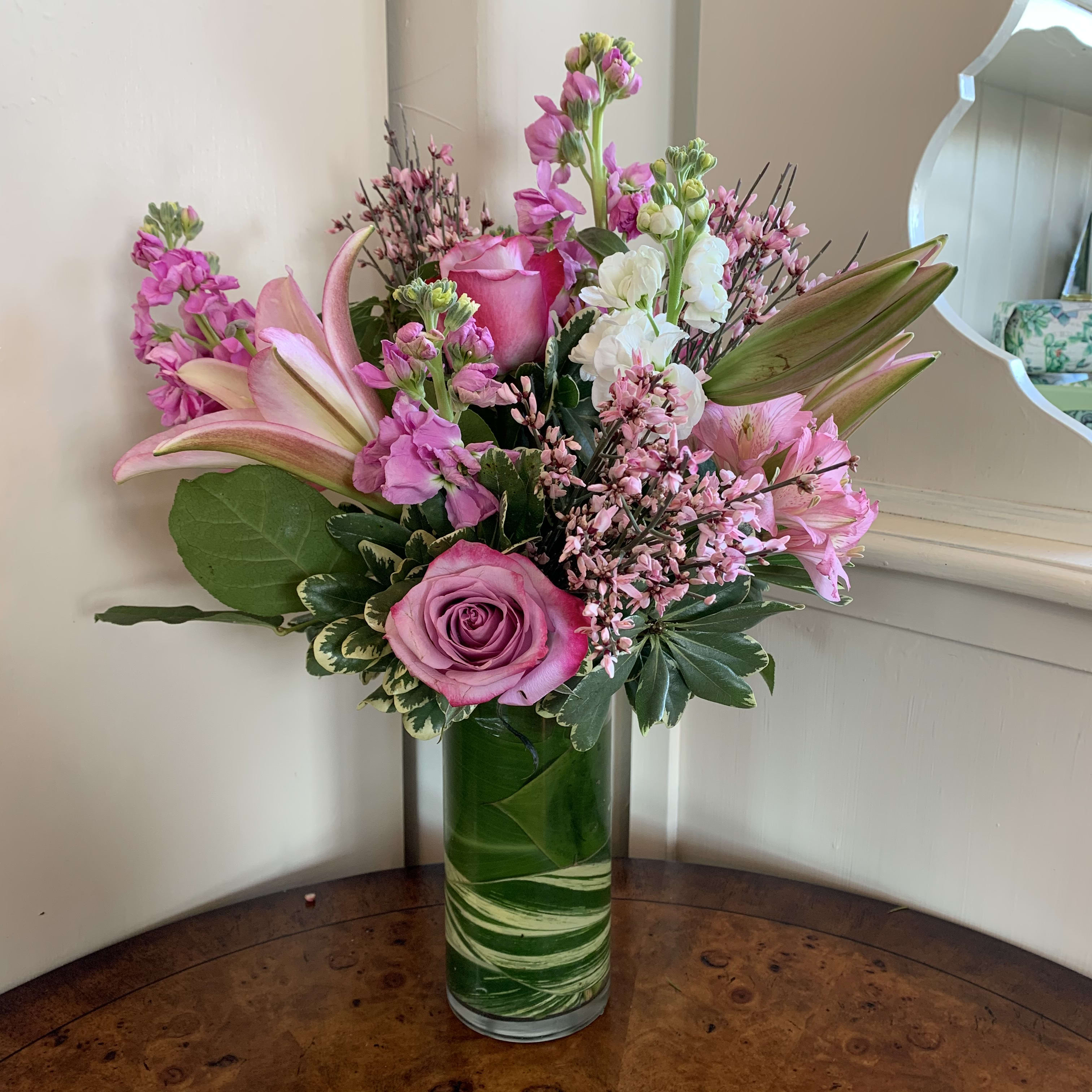 Just For You Bouquet Just For You Bouquet - Pink roses, lilies, stock and complimenting filler flowers with greens in a 7" tall leaf lined glass cylinder vase. Regular in approximately 14" high and 10" wide. Deluxe has more flowers and same dimensions . Premium is in a taller 9" vase and the arrangement 17" Tall x 12" wide