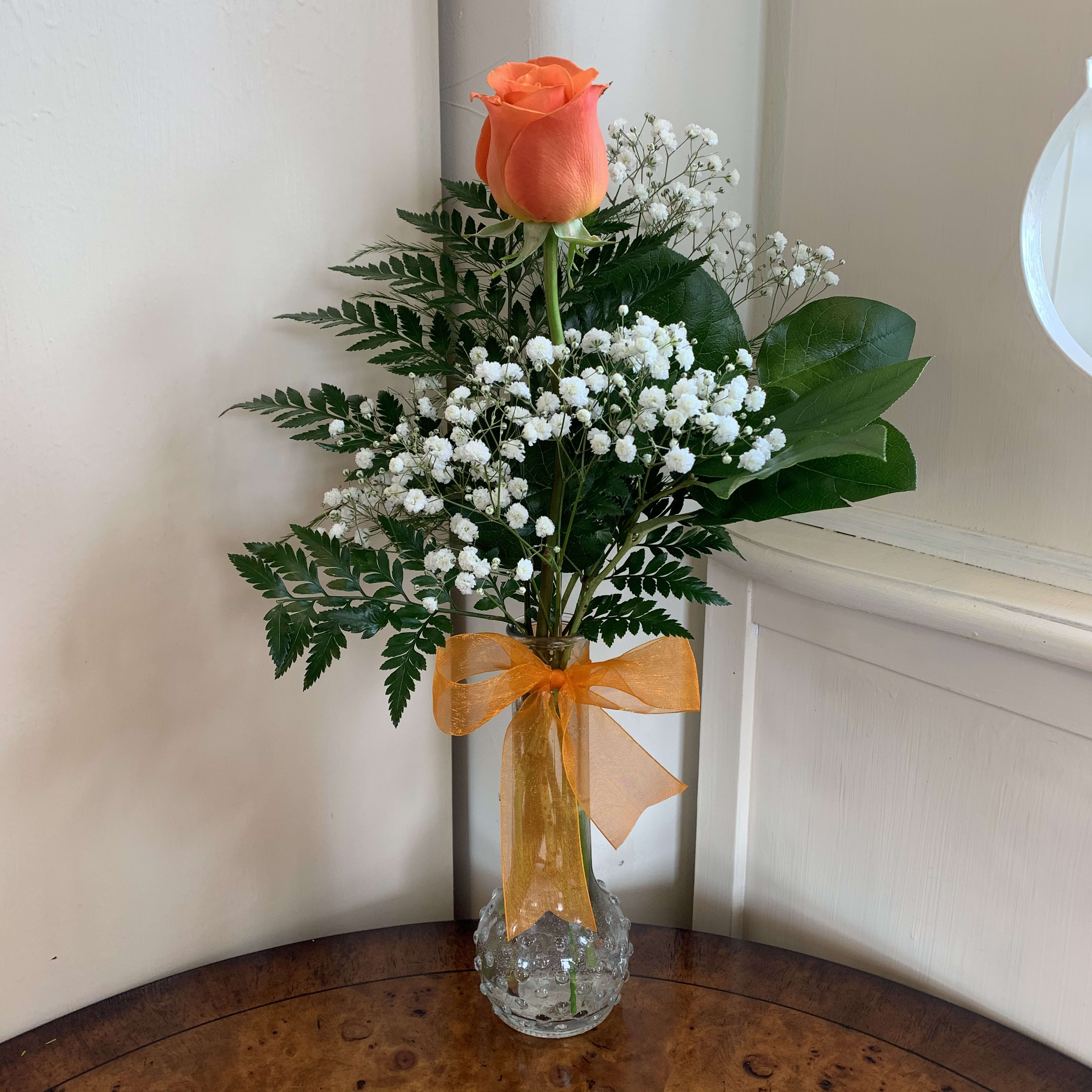 Orange Sweetheart Bud Vase Orange Sweetheart Bud Vase - Orange rose and babysbreathj and greens in a glass bud vase. Orange organza bow