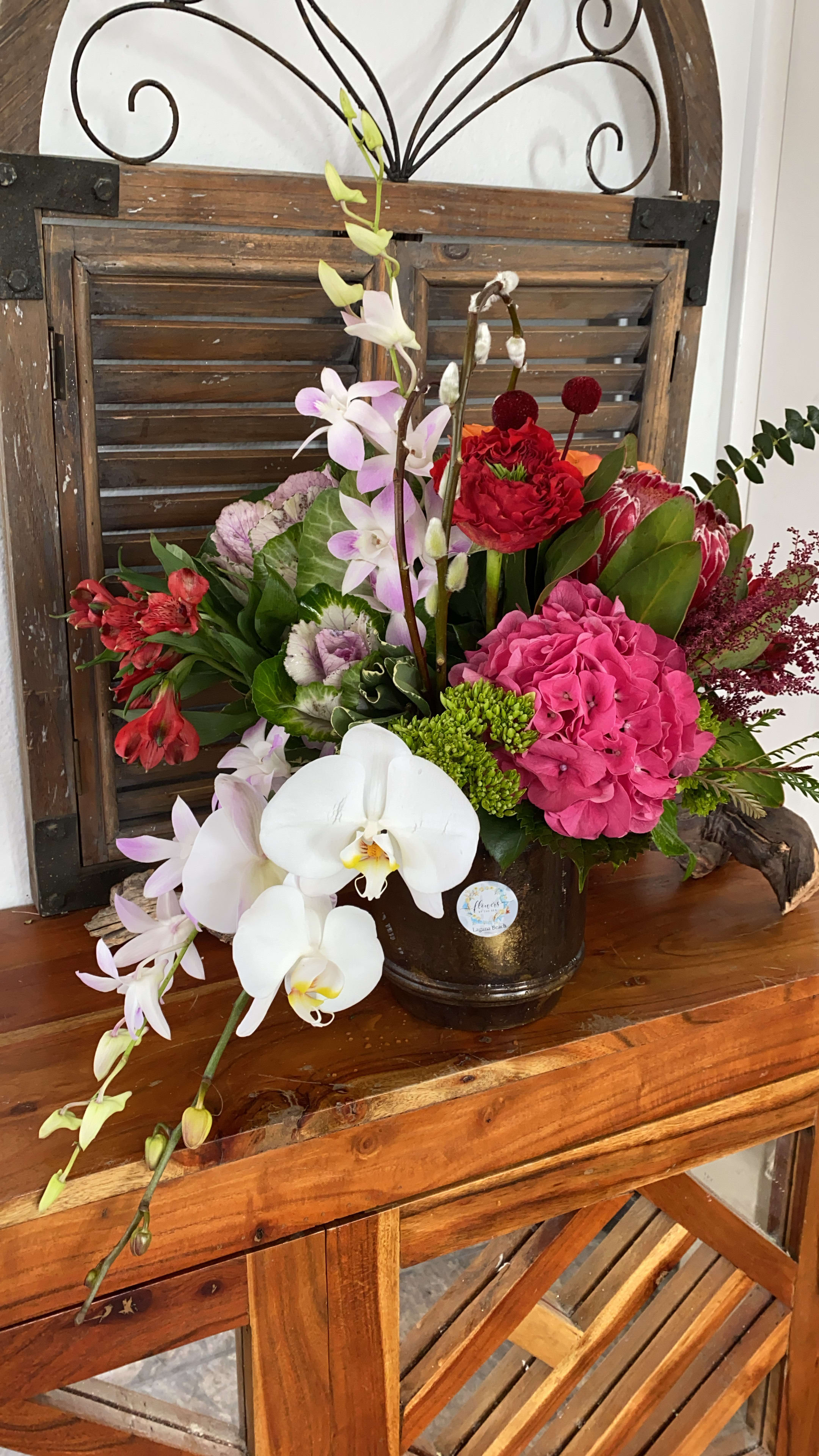 Tropical Love  - Amazing!!! Bouquet of Tropical flowers in brown metallic container, is a game of colors in hot pink, reds and purples.   