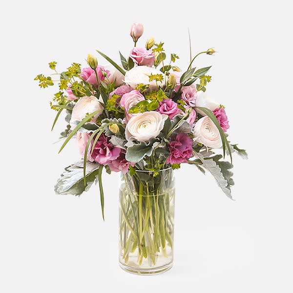 Tulle - [ Height: 18'' - 19'' | Diameter: 11'' - 12'' ] Airy and feminine, this lovely display may elicit a matching blush. Pink ranunculus, lisianthus, and carefully selected greens make this delicate arrangement.  Plantshed delivers flowers around your schedule seven days a week.