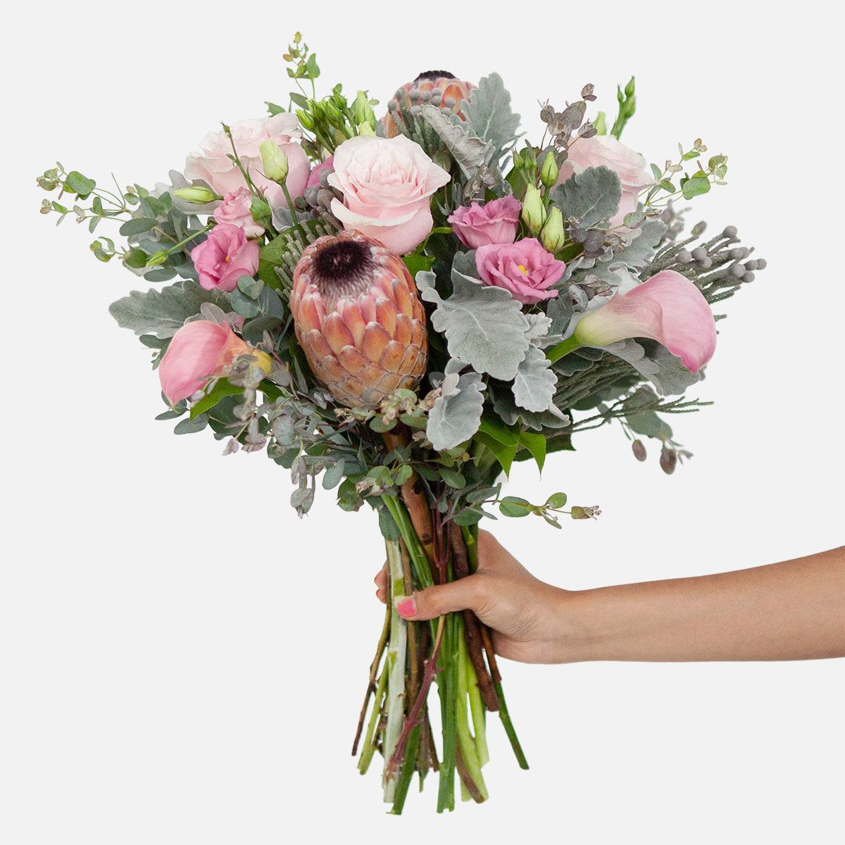 Olivia Bouquet - A handcrafted bouquet of blush pink roses, calla lilies, lisianthis, and protea with elegant dusty miller, wrapped in brown kraft paper. Perfect for a small or medium-sized vase (vase not included).