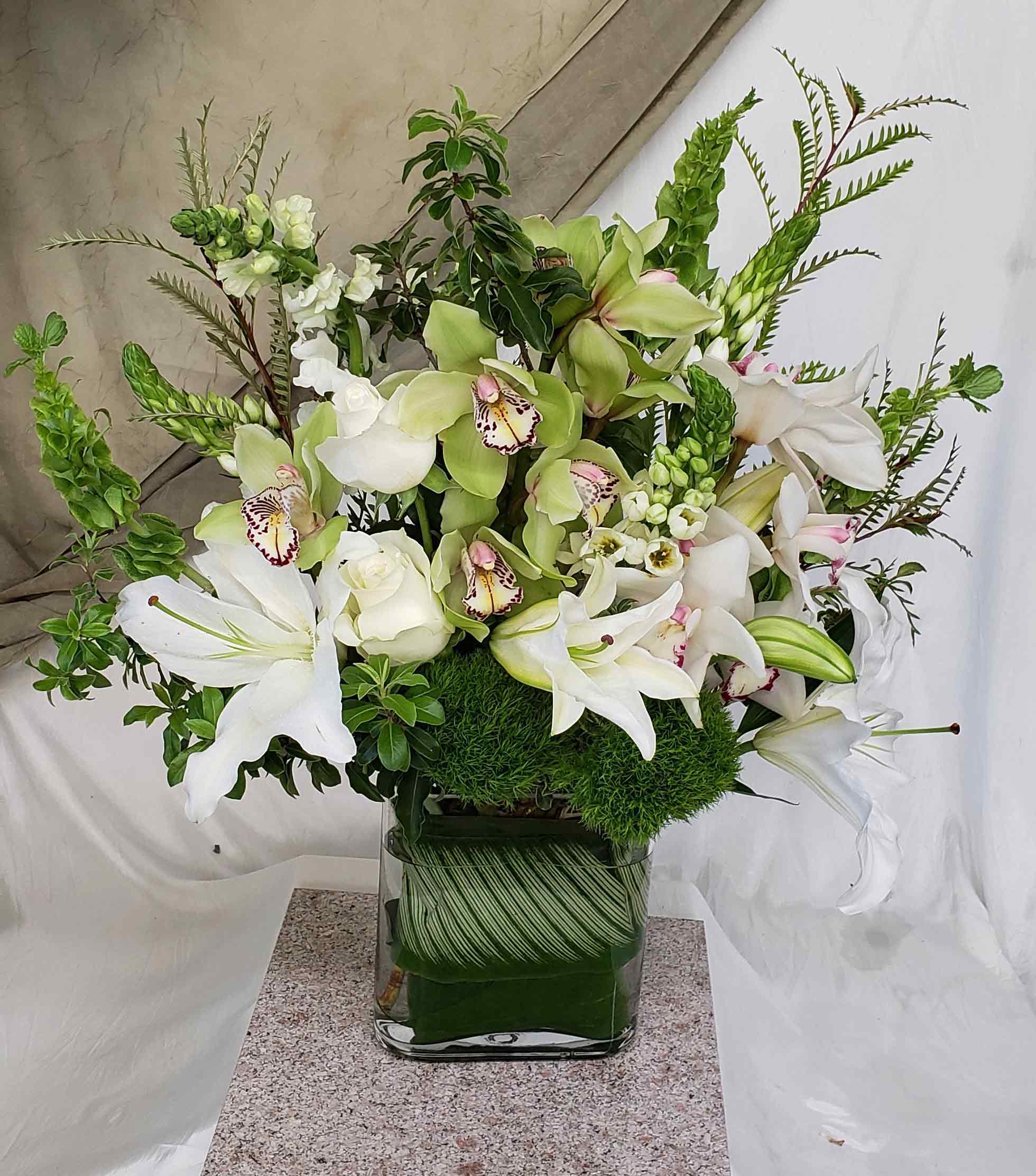 Respectful (AW-5) - Roses, Lilies, Cymbidium Orchids, Snapdragons, Bells of Ireland &amp; more.