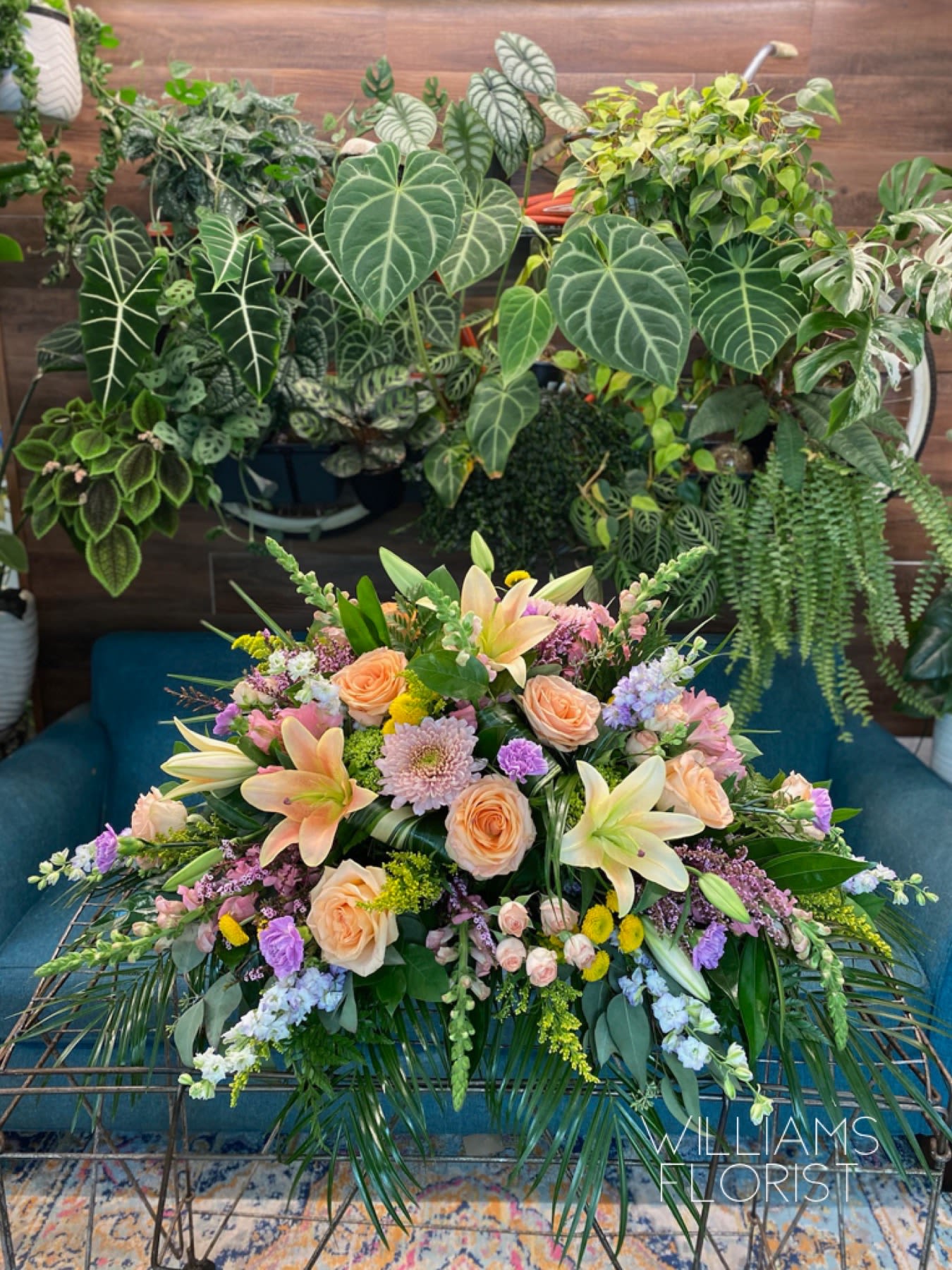 Garden of Sweet Memories Garden of Sweet Memories - Bring a gentle radiance to the memorial service with this lovely multicolored casket spray of roses lilies and other favorites. A beautiful way to honor the departed. The elegant arrangement includes purple hydrangea, roses, peach spray roses, Lillies, carnations, snapdragons lavender stock and solidago accented with assorted greenery.