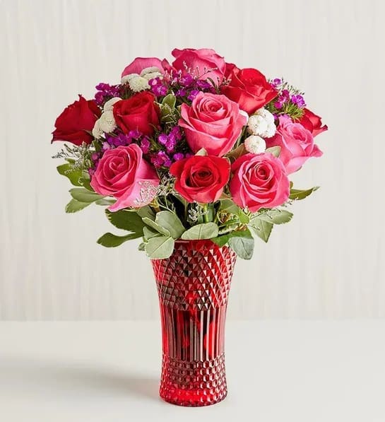 Key to My Heart® Bouquet - The key to an unforgettable Valentine’s Day. Red, pink, and purple blooms are arranged in our luxurious red vase, creating a statement as vibrant and dazzling as your love.  Note: To guarantee the freshest bouquet possible, our florists may replace some stems in your arrangement which could differ in color and variety.