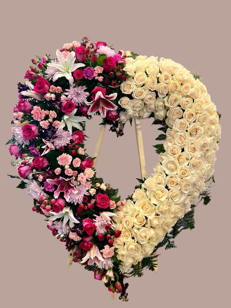 Half Of my Heart Half Of my Heart - Graceful and timeless, our standing open heart arrangement speaks volumes when words fall short. Crafted with tender care and delicate blooms, it offers a touching tribute at any funeral service, embodying love and remembrance. Approx 25-28 inches