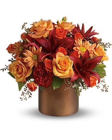 Teleflora's Amazing Autumn Teleflora's Amazing Autumn - Autumn is an awesome season and it's meant to be celebrated in style. Rich fall hues are on brilliant display in this beautiful arrangement that comes delivered in an elegant satiny brown cylinder vase. Gorgeous orange roses, spray roses and chrysanthemums, dazzling burgundy asiatic lilies, red carnations, and eucalyptus and even preserved yellow oak leaves are splendidly arranged in a satin vase. It's amazing, all right! Orientation: All-Around