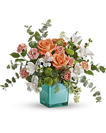 Teleflora's Sunset Splash Bouquet Teleflora's Sunset Splash Bouquet - Make a splash on any occasion with this wow bouquet! A fun-filled play on color, it contrasts pretty peach and white blooms with a watery aqua cube vase that's sure to become one of their year-round décor faves. This delightful arrangement features peach roses, white alstroemeria, peach miniature carnations, green button spray chrysanthemums, spiral eucalyptus, seeded eucalyptus, oregonia, and lemon leaf. Delivered in Teleflora's Aqua Color Splash Cube. Orientation: All-Around