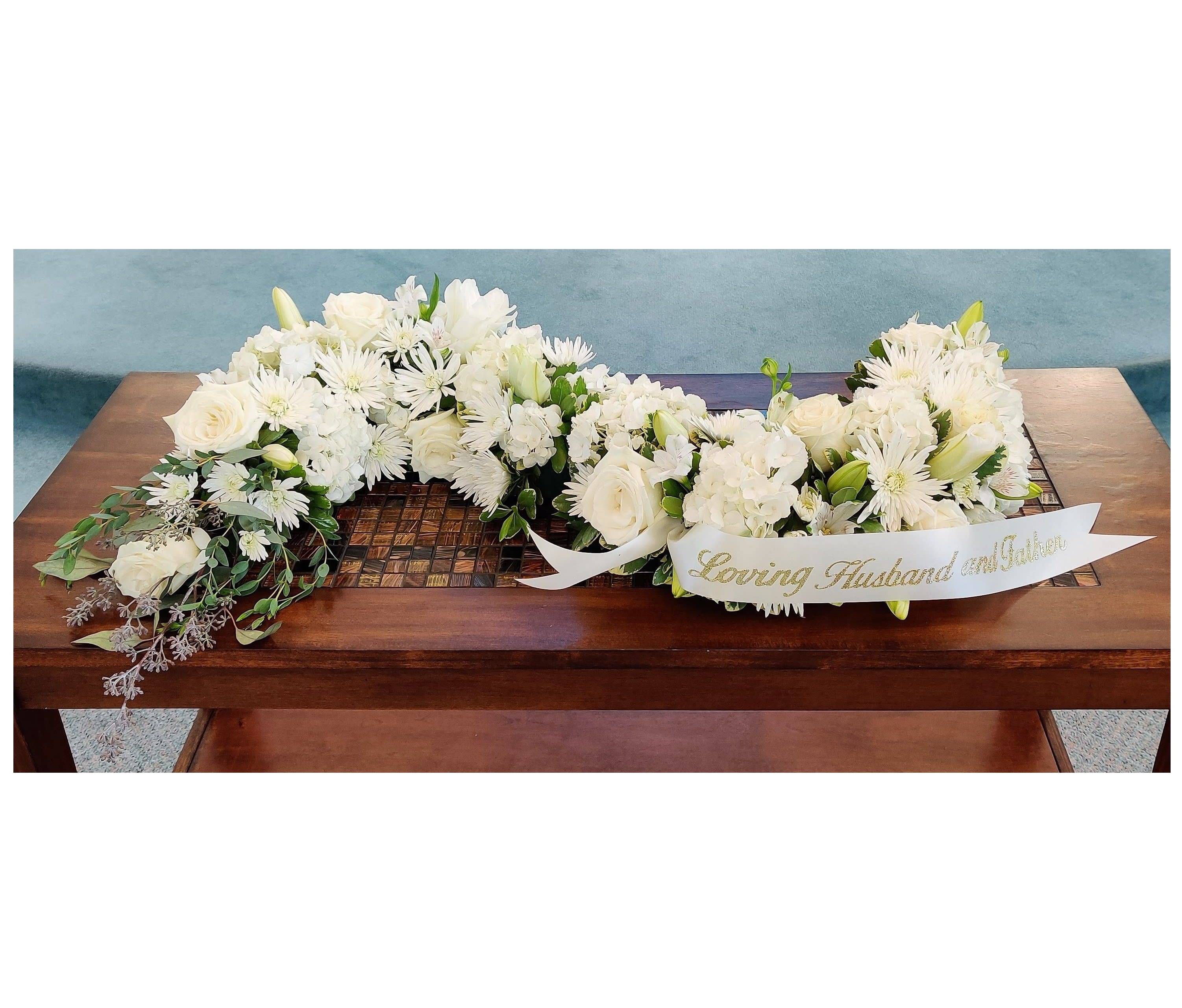 Elegant White S-Shaped Urn Surround ~ Flower A Day - Our signature S-Shaped Urn Surround arrangement made with elegant mixed blooms in shades of white provides a gracious tribute for a somber occasion. Our hand designed, &quot;s&quot; shape will surround the urn in love. (Cremation service).  Script and banner NOT included.  