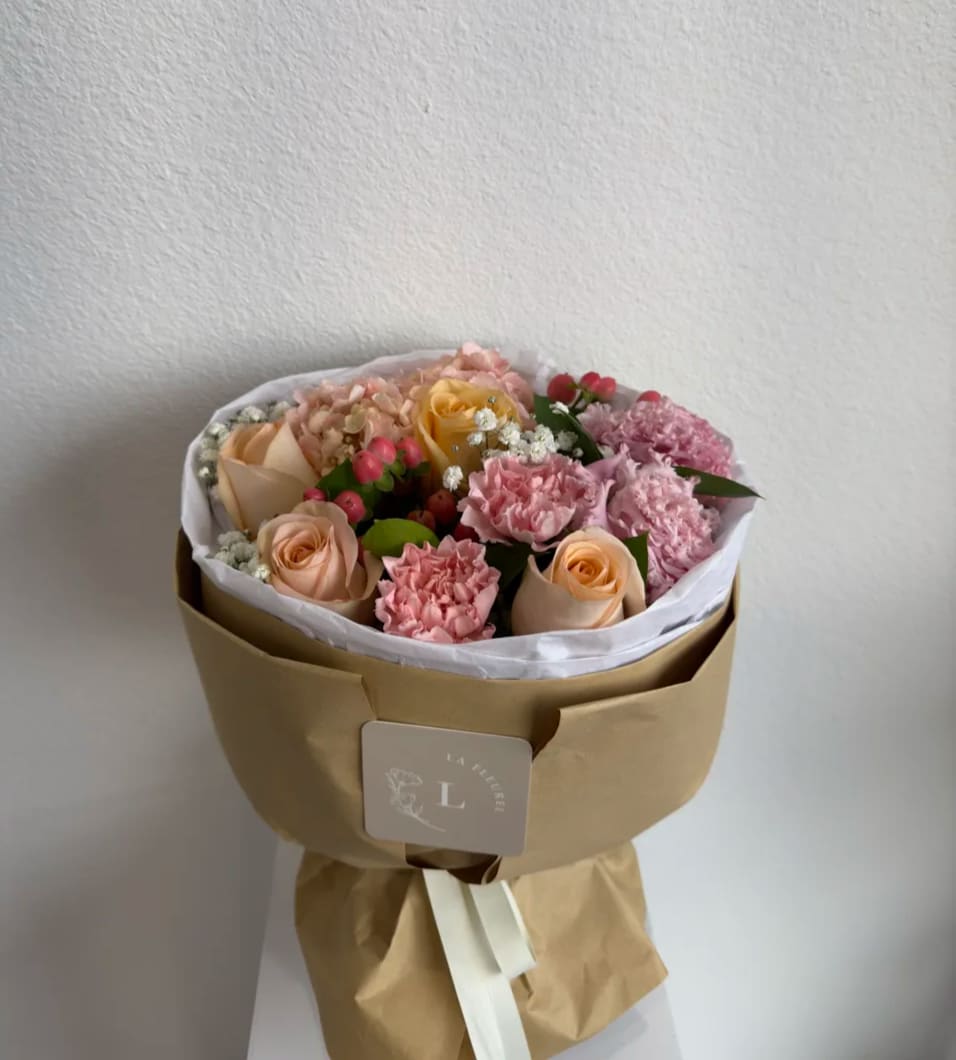 Candy Bouquet - Our hand tied bouquet comes without a vase which makes it perfect for a recipient who loves to arrange flowers on their own or who already has a stellar vase! Bouquet wrapped in brown paper   Perfect for any occasion.