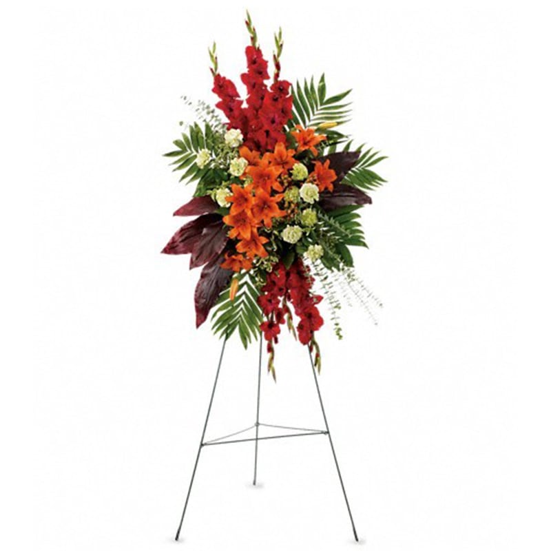  A New Sunrise Spray  - When a loved one has passed, this radiant spray of red and orange flowers will be a reminder of happy times past that will never be forgotten.  The stunning arrangement includes orange Asiatic lilies, red gladioli, green carnations, peach hypericum, emerald palm and red ti leaves, accented with assorted greenery.  Approximately 31&quot; W x 50&quot; H  Orientation: One-Sided