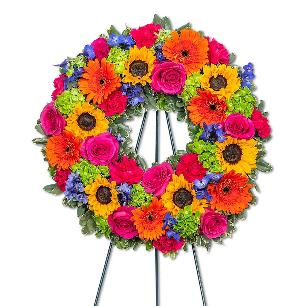 Forever Blooming Bright Wreath Forever Blooming Bright Wreath - Our Forever Blooming Bright Wreath is a breathtaking design that radiates vibrance and beauty with its vivid palette. These magnificent memorial flowers are designed to honor and celebrate a life lived with boldness and brilliance, capturing the essence of cherished memories that will forever remain in our hearts.