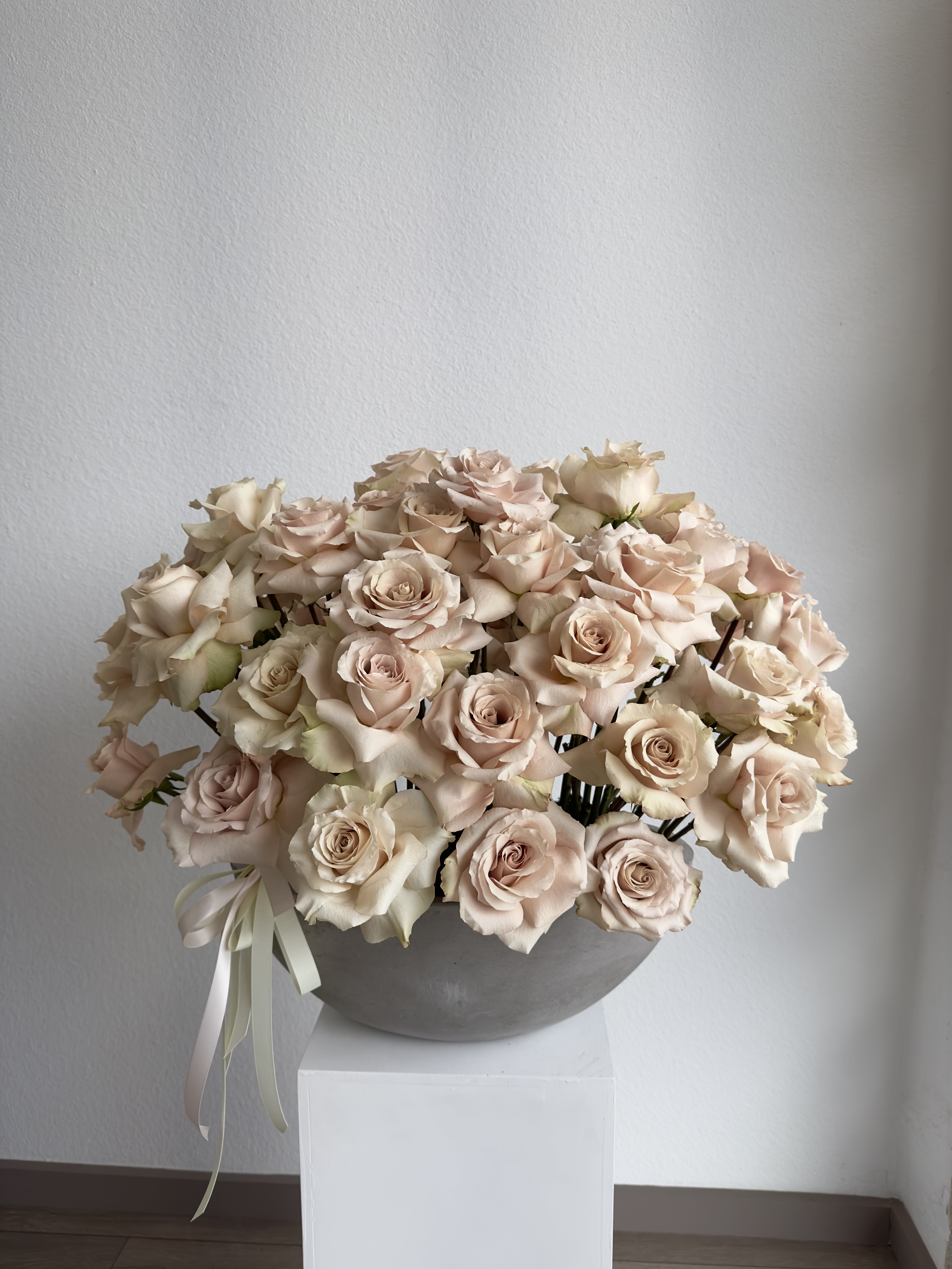 Pastel Perfection Arrangement - Our luxury arrangement of 50 quicksand roses in a beautiful concrete vase.  Arrangement includes: beige roses Ceramic Vase 18-20 inches in diameter  Custom greeting card