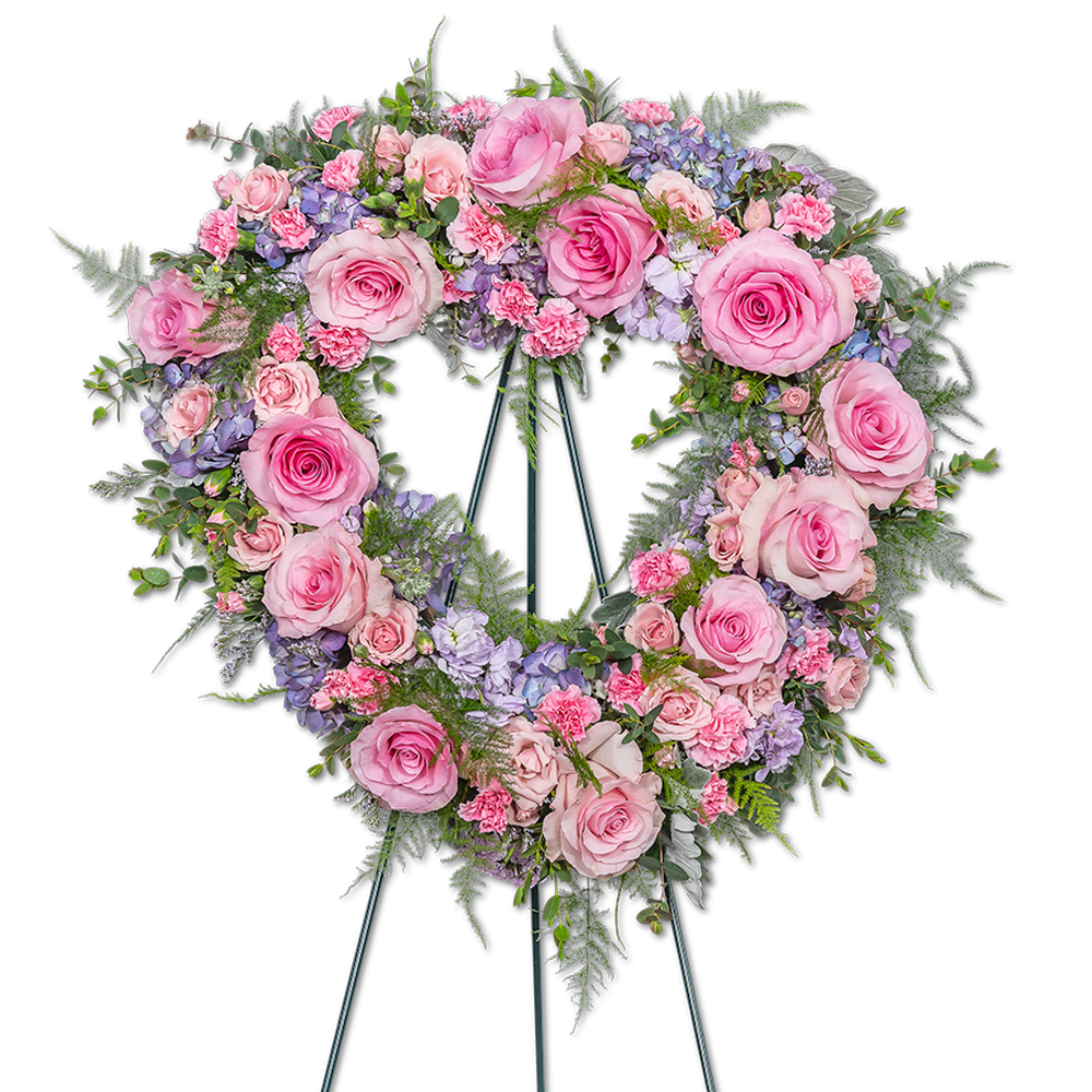 Glorious Garden Standing Heart Glorious Garden Standing Heart - Our Glorious Garden Standing Heart is a breathtaking floral tribute that embodies the essence of a serene and enchanting garden. This meticulously designed standing spray combines delicate shades of pink and purple, harmoniously surrounded by lush green foliage, creating a truly awe-inspiring display. The soft hues of pink and purple reflect tenderness, compassion, and heartfelt emotions. This design reflects the cherished memories shared with your loved one, celebrating a life lived with grace and leaving a lasting impression of their extraordinary presence.