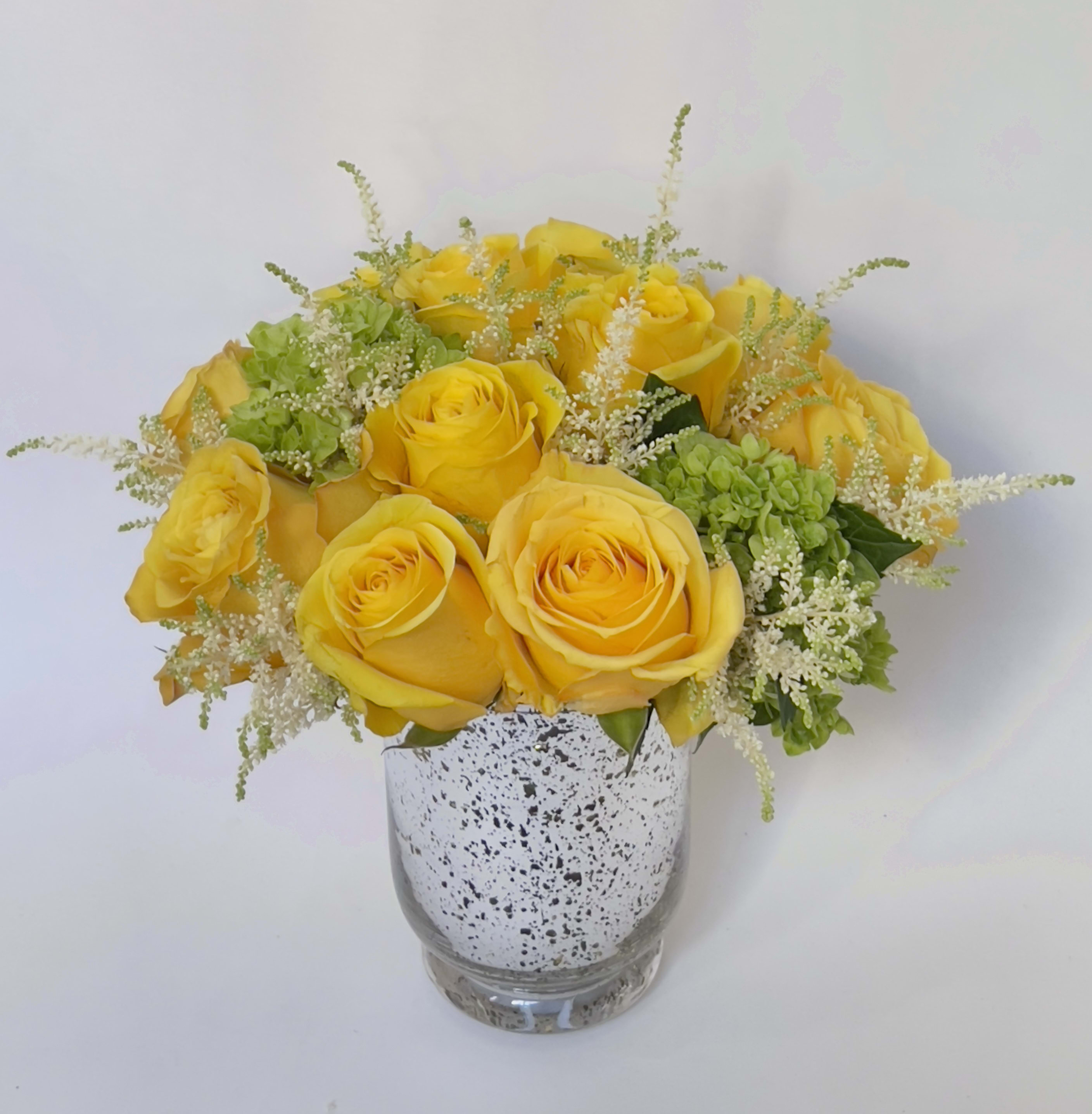 Golden Birthday  - Simplicity is key. This elegant flower arrangement in a vase features the beautiful yellow rose, a symbol of friendship, accented with classic green hydrangea. Show your closest friends how much they mean to you with this bright and colorful bouquet. Vase will vary based on availability.