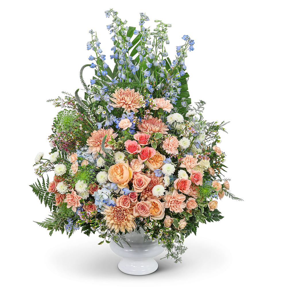 Meadow of Memories Urn Meadow of Memories Urn - Our Meadow of Memories Urn is a stunning tribute designed to honor and celebrate the life of your loved one. These memorial flowers are a radiant tapestry of peaches, blues, and greens, captivating the eyes and soothing the soul with their serene beauty. It serves as a beacon of comfort and solace, and its breathtaking combination of flowers and colors serves as a beautiful final farewell, evoking a sense of everlasting love and reverence for the life that was lived.