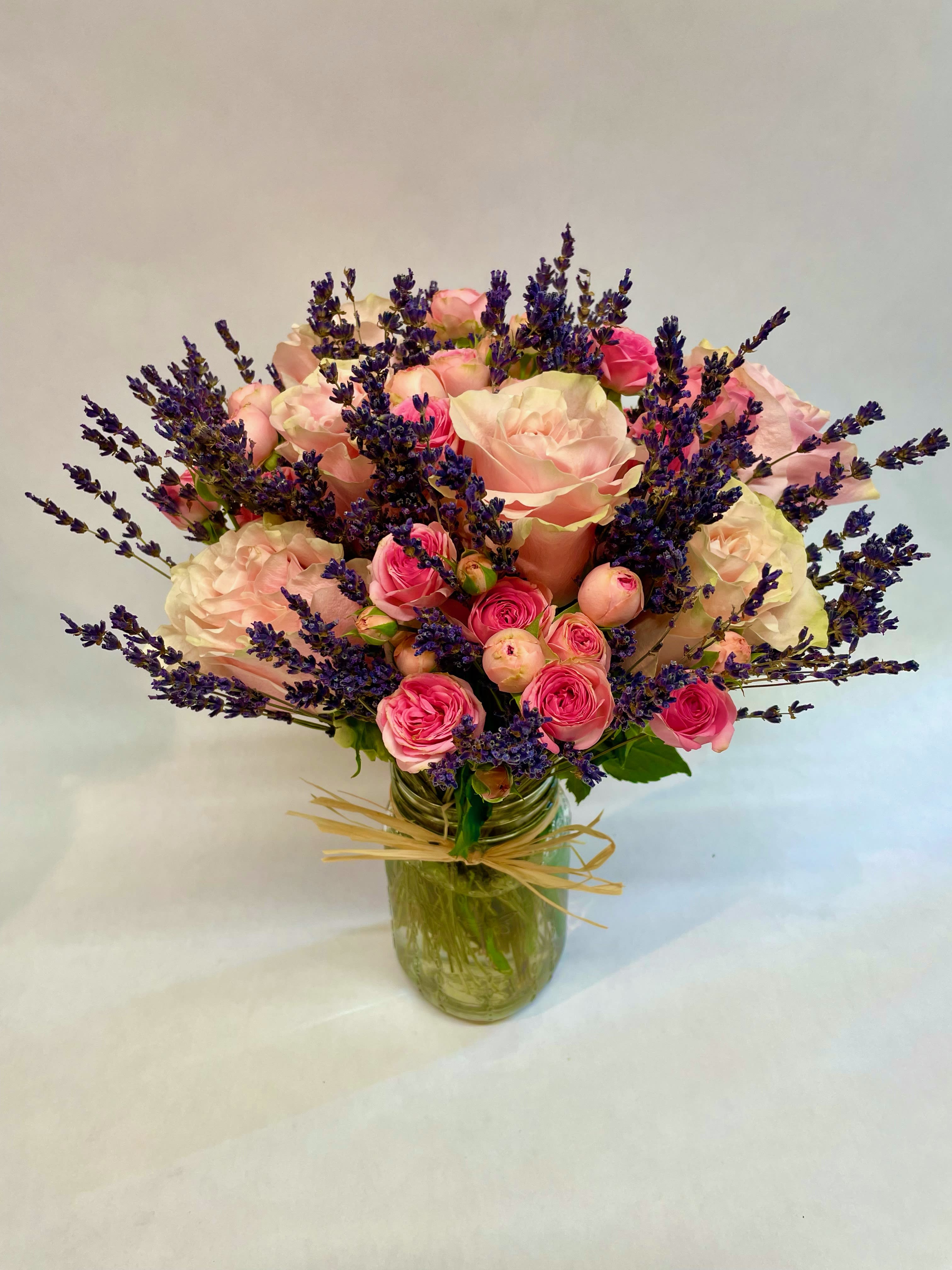Provence Lavender Mixed Rose arrangement  - A stunning rose variety-- this sweet and fragrant jar features one dozen premium quality pink roses and spray roses ( also available in peach, red, orange, lavender and yellow color ) paired with dried French lavender. A stunning sentiment for someone special. Featured Jar :$85.99.