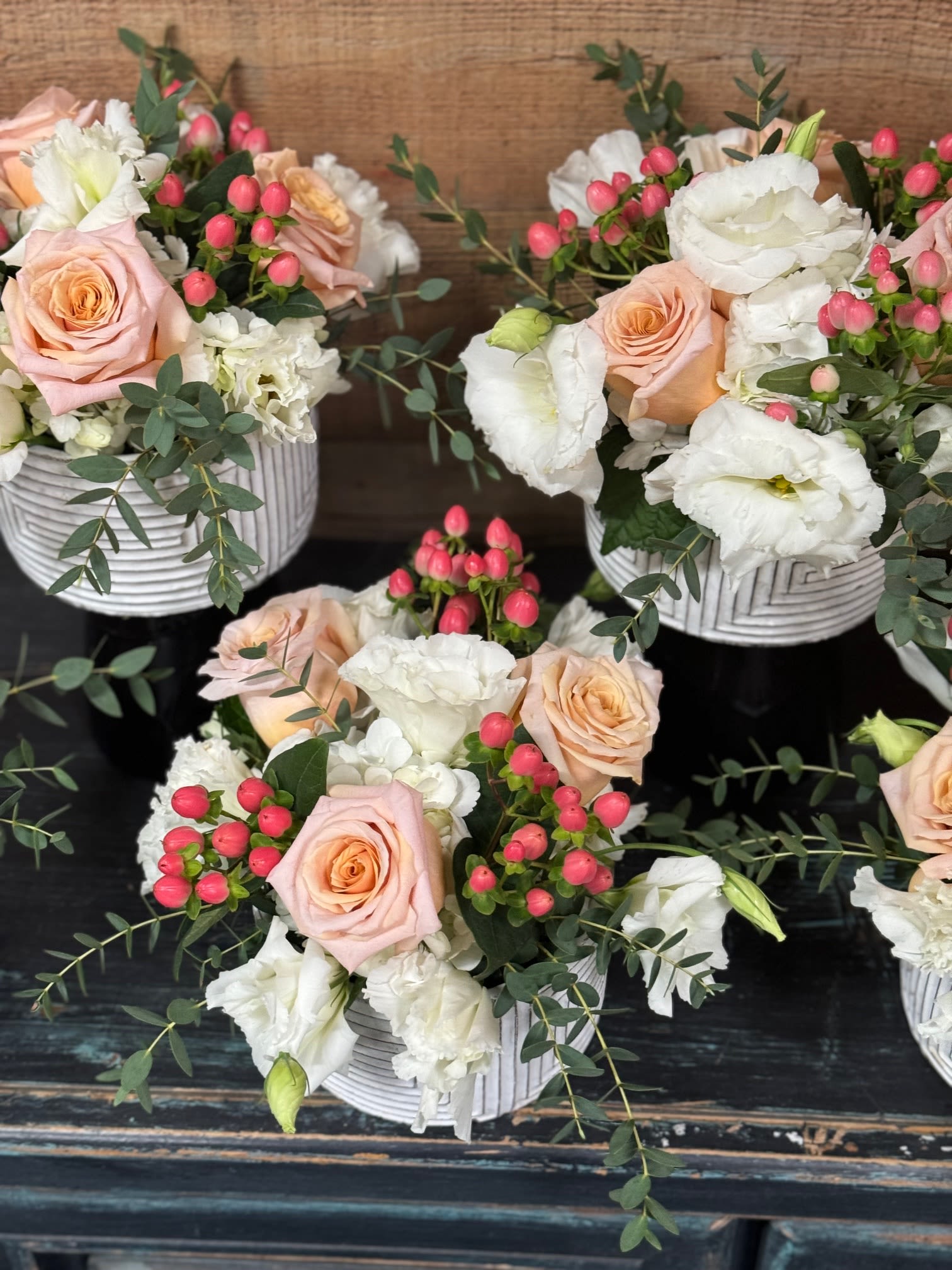 Centerpiece 2 - Centerpiece in beautiful white and peach colors in a low white vase Vase design may vary. Sold in quantities of  3, 6, and 10. Please give us a call if you would like a different quantity or same design but in different colors