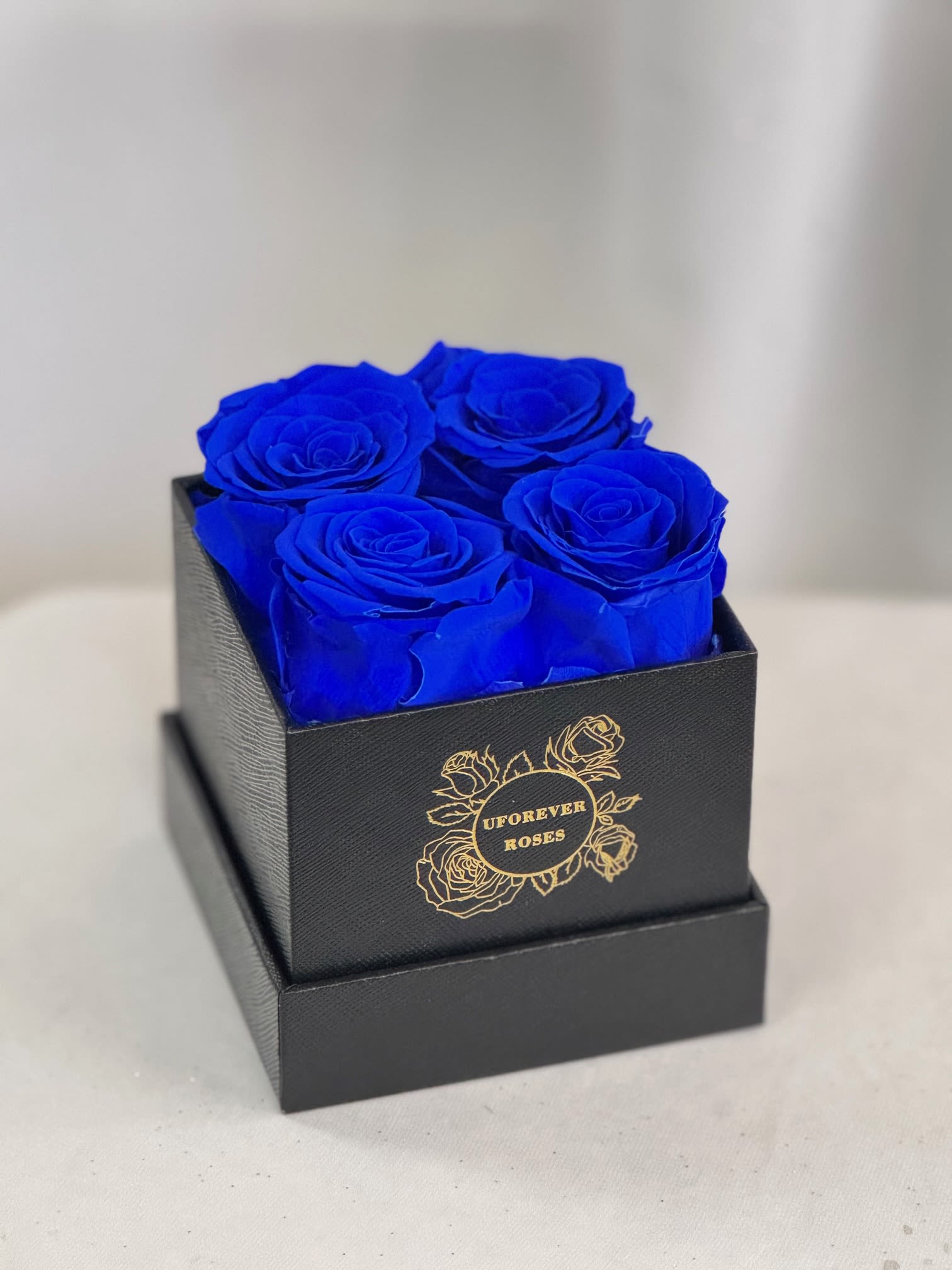 Forever Roses Royal Blue  - A lasting luxurious gift of roses, that will impress your special someone and bring them joy every time they see them.  A beautifully quality preserved rose chosen at the peak of perfection and then preserved to maintain the original natural beauty of each unique rose. A luxurious and romantic gift of love and adoration to cherish over time. They are preserved and, with proper care, will stay just as beautiful for up to a year or longer.  Care Instructions: Arrangements do not require watering; for maximum beauty, keep away from extreme sunlight &amp; humidity  Roses and hat box arrive inside a decorative gift box with ribbon.  Item dimensions L x W x H: 4 in x 4 in x 5.25 in 4 Royal Blue Roses 