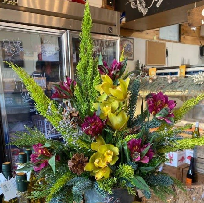 Show Stopper - This large eye catching piece is made up of orchids, alstroemeria, and seasonal greens. 