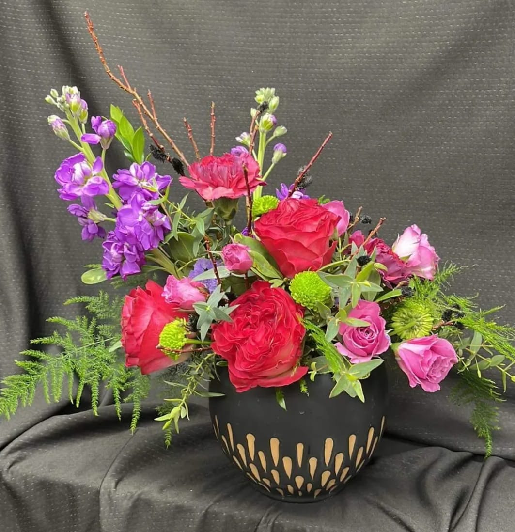 Ceramic rose - This arrangement is made up in a plant pot for a unique way to reuse the container. this arrangement includes roses, spray roses, and stock. 