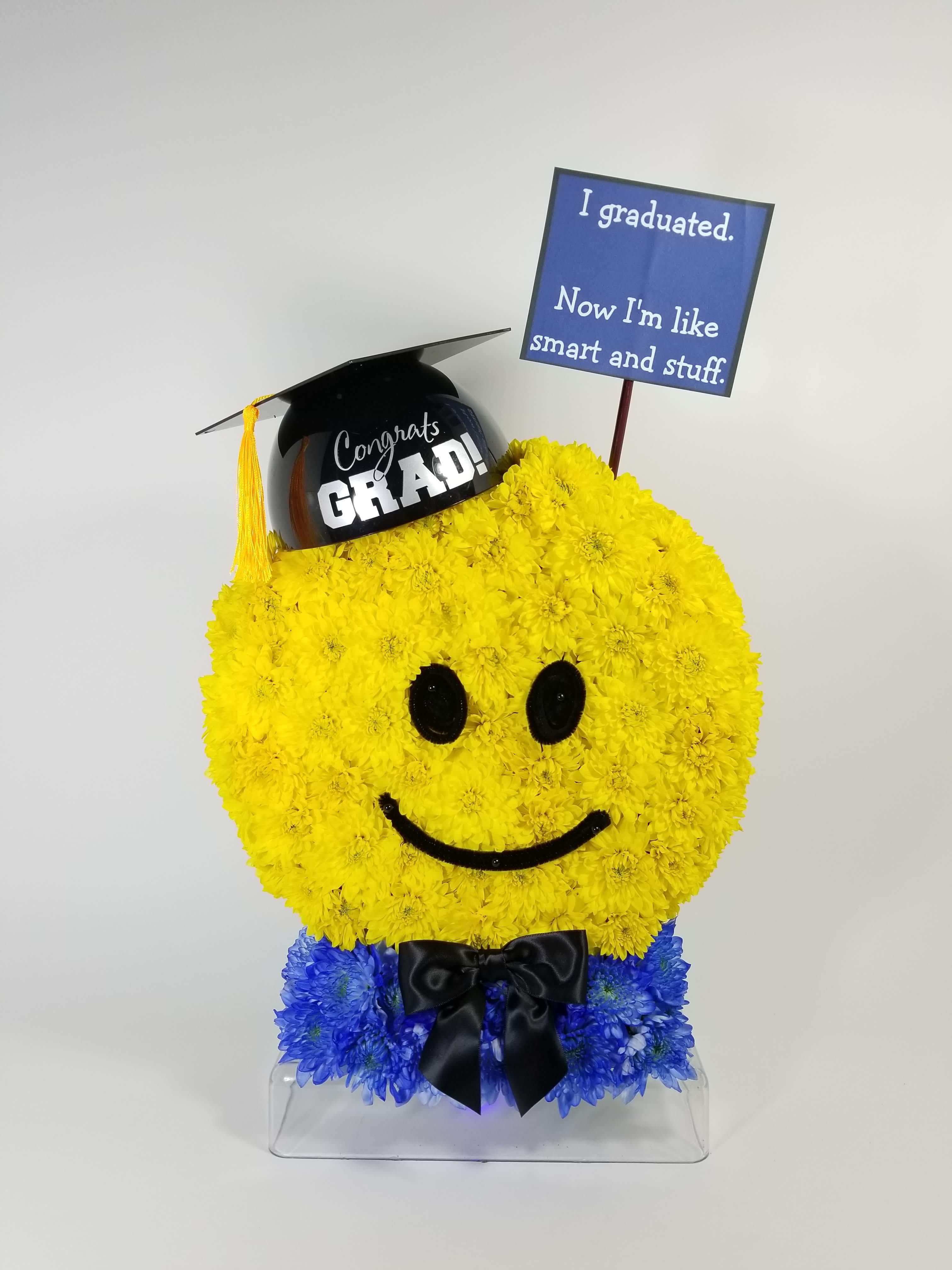 I Graduated - Emoji face made with flowers and graduation props