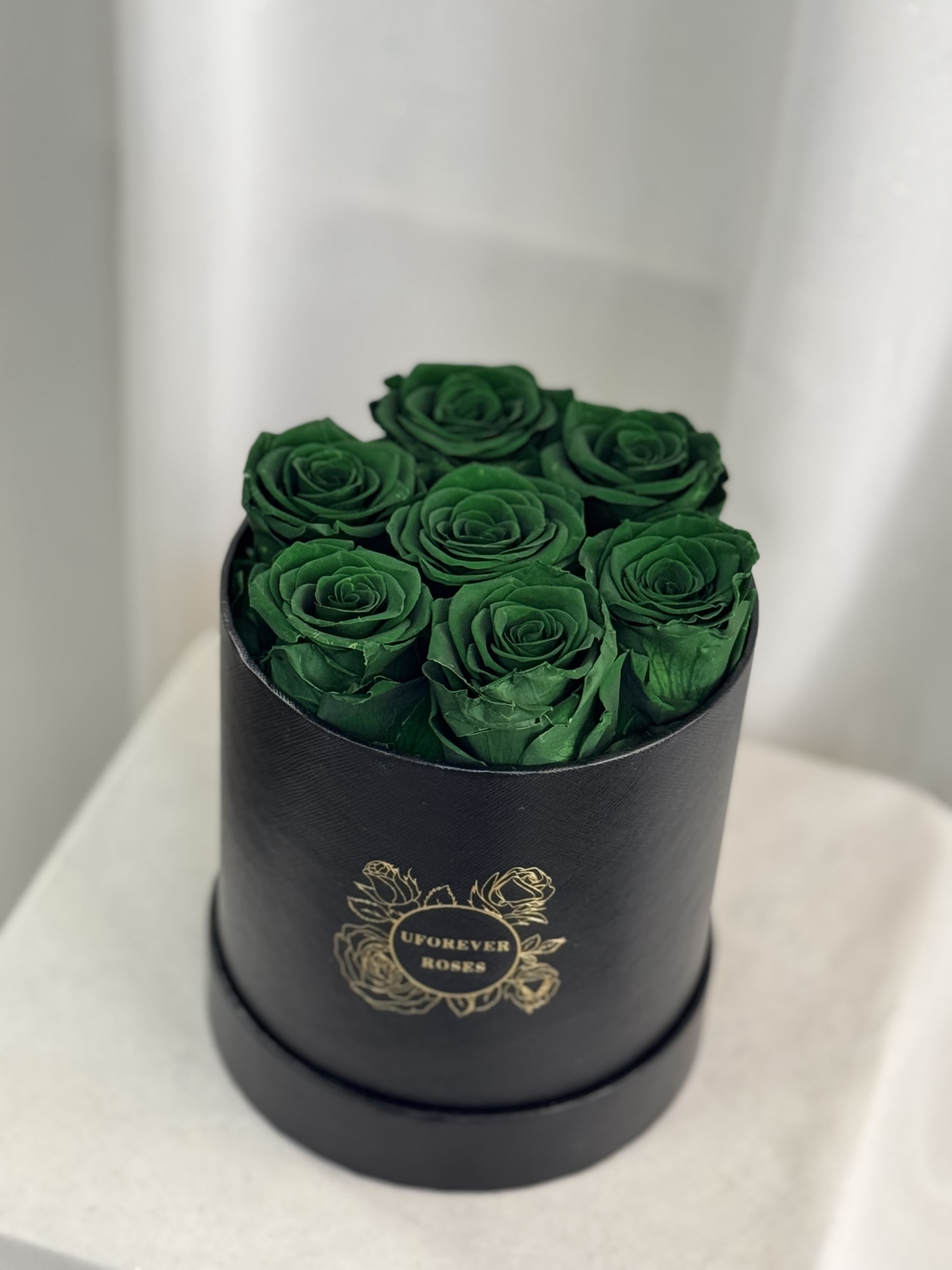  Forever Roses in Green  - A lasting luxurious gift of roses, that will impress your special someone and bring them joy every time they see them.  A beautifully quality preserved rose chosen at the peak of perfection and then preserved to maintain the original natural beauty of each unique rose. A luxurious and romantic gift of love and adoration to cherish over time. They are preserved and, with proper care, will stay just as beautiful for up to a year or longer.  Care Instructions: Arrangements do not require watering; for maximum beauty, keep away from extreme sunlight &amp; humidity  Roses and hat box arrive inside a decorative gift box with ribbon.  Item dimensions Height x Diameter: 7in x 5.5in 7 Green Roses 