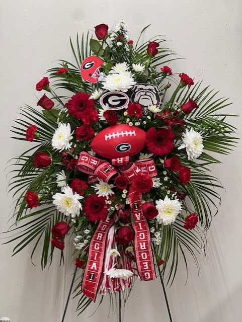 Georgia Bulldog Spray - Local Delivery Only - This spray was designed for a fan of the Georgia Bull Dogs. It has Red Gerbera Daisies, Red Roses, Red Carnations, Red Alstreomeria, and White Fugi Mums. The Decor in the spray can change due to what we have available. LOCAL DELIVERY ONLY   FCF-0182