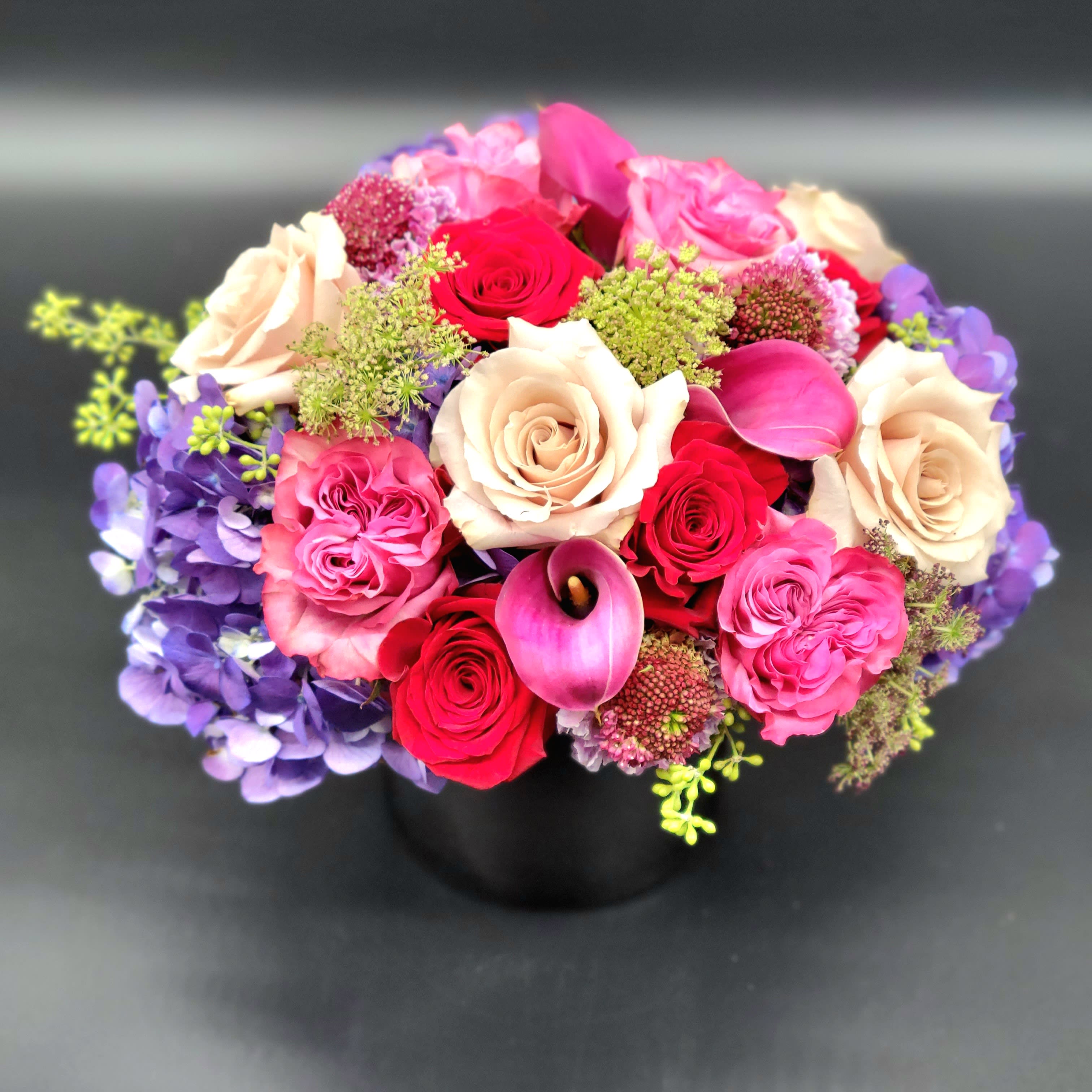 Valentines Day Special Valentines Day Special - A lush mix of romantic blooms in shades of pinks and reds, sure to tug at any heartstrings. Flowers will vary but include some combination of roses, hydrangea, sweet pea, ranunculus, lysianthus, hyacinth and clematis.