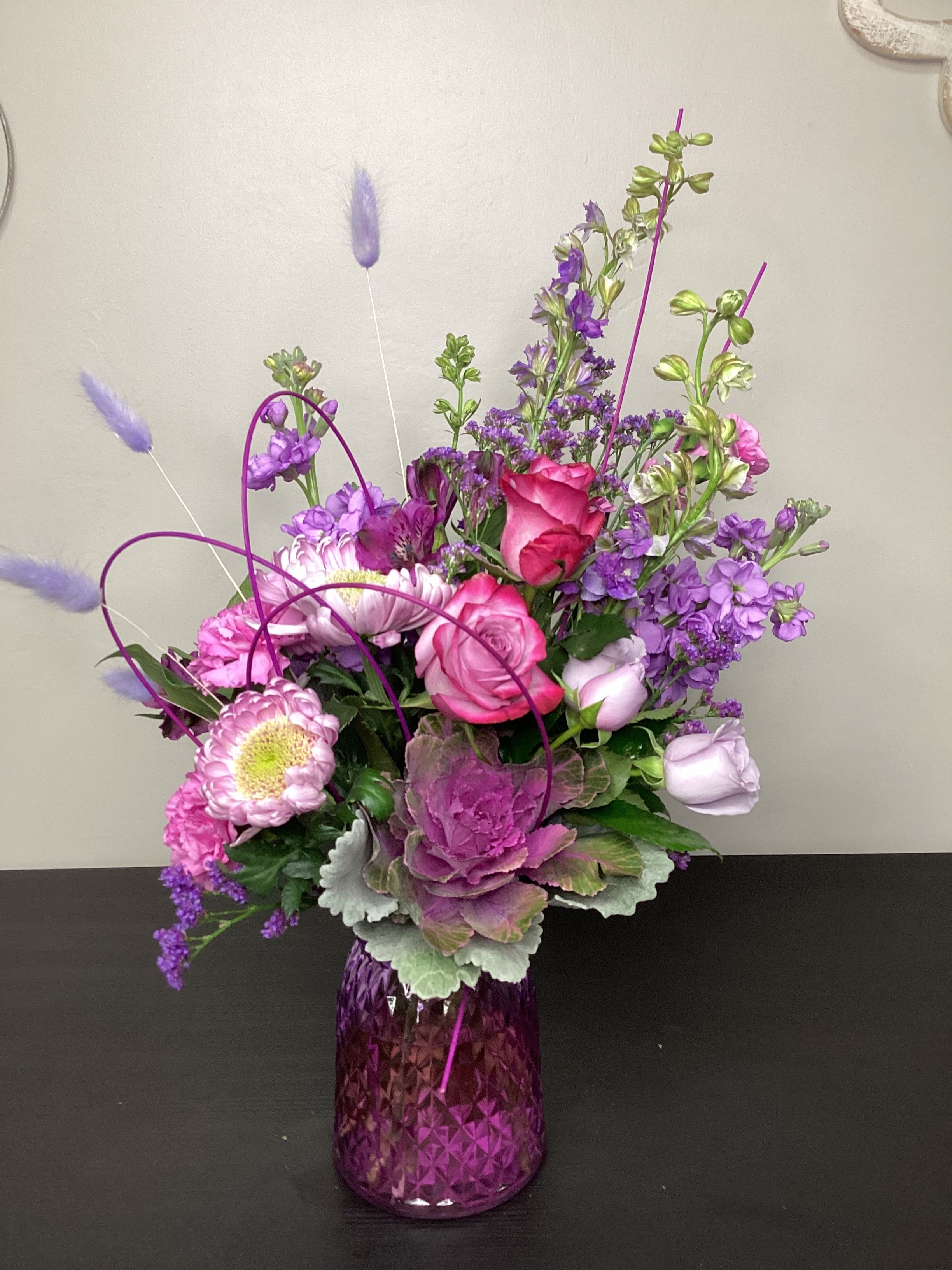  Laughter in Lavender - A fun mono-shaded collection of Lavender and purple hues, made of the freshest selection of flowers chosen by our design staff. We even added stems of midolino in vibrant violet to give movement across the design. 