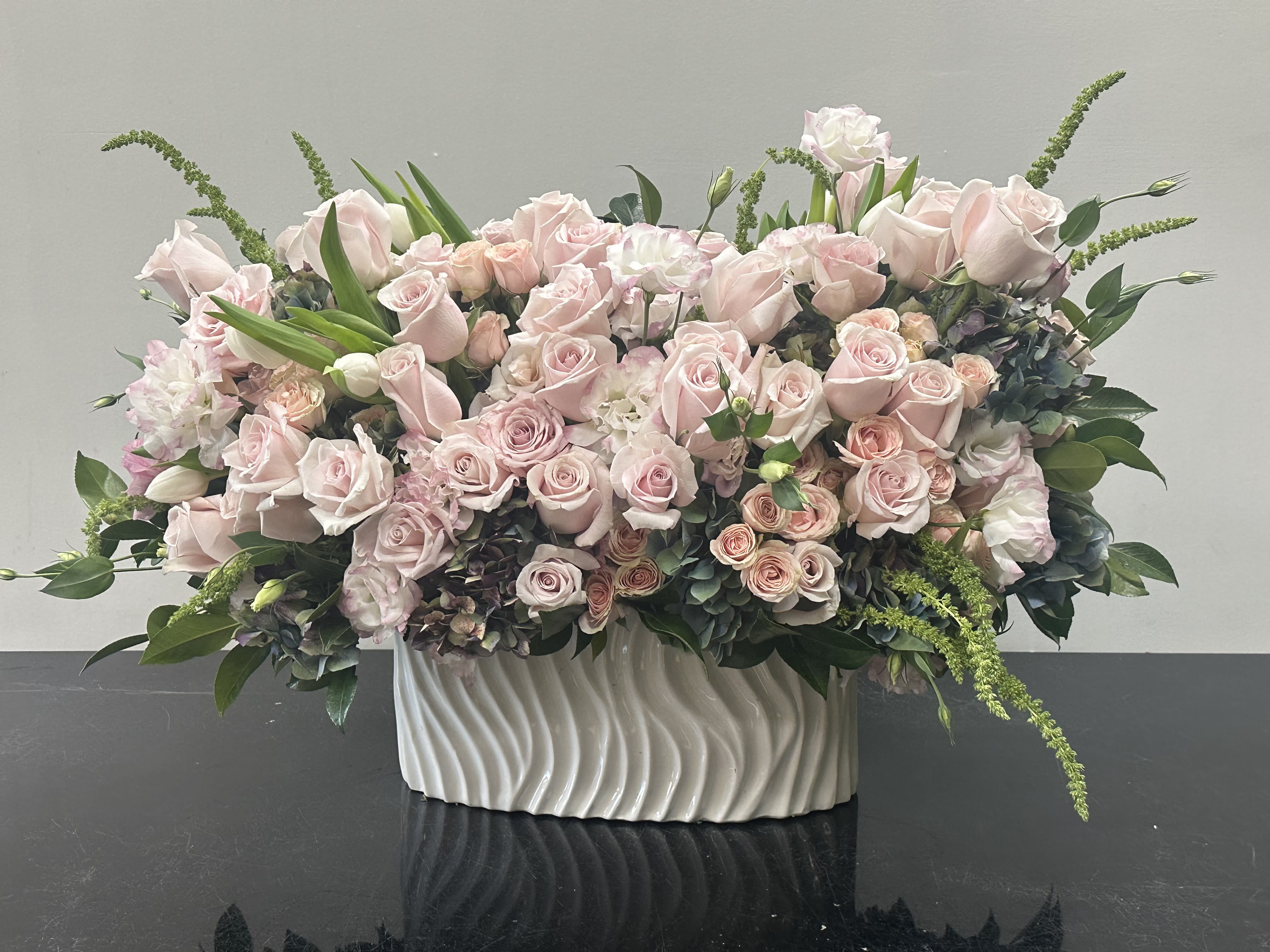 Pink Sorbet Pink Sorbet - Charming and lovely, pink sorbet is a lush floral design adorned with blush pink blooms and wild greenery sprouting from all sides is the perfect display for a perfect ambiance. Roses, lisianthus, tulips, spray roses, hydrangeas, greenery Some florals are seasonal, if particular flower will not be available due to season, we will substitute for similar flower, composition, color pallet and value of the arrangements as closely as possible. All effort to create a floral arrangement as close to the photo shown, the actual arrangement may vary slightly in its appearance from the photo shown. If you have any questions about your order, we welcome you to call us in or email