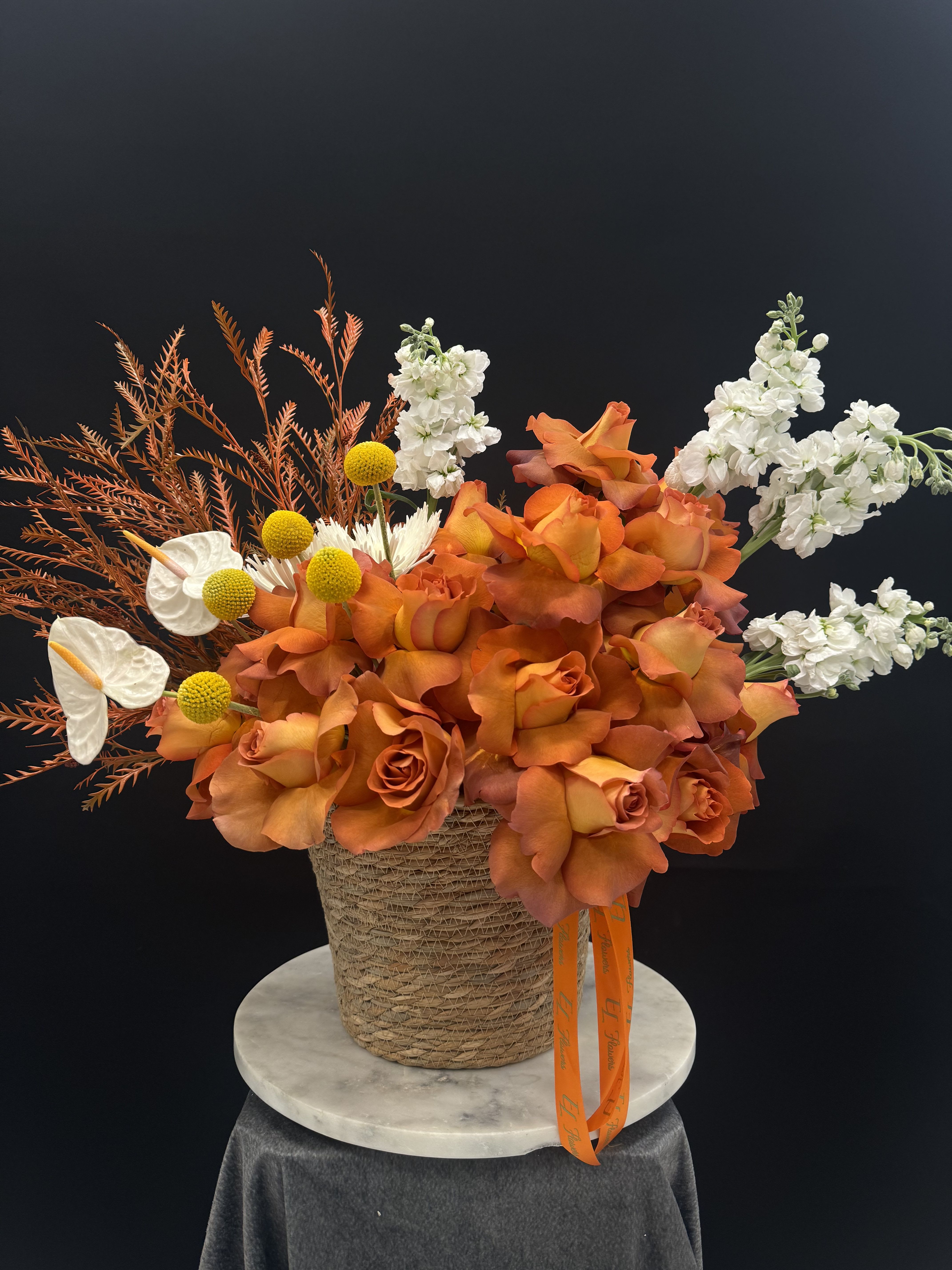 Sunset Serenade Sunset Serenade - Orange ombre roses with white anthuriums and unique fillers