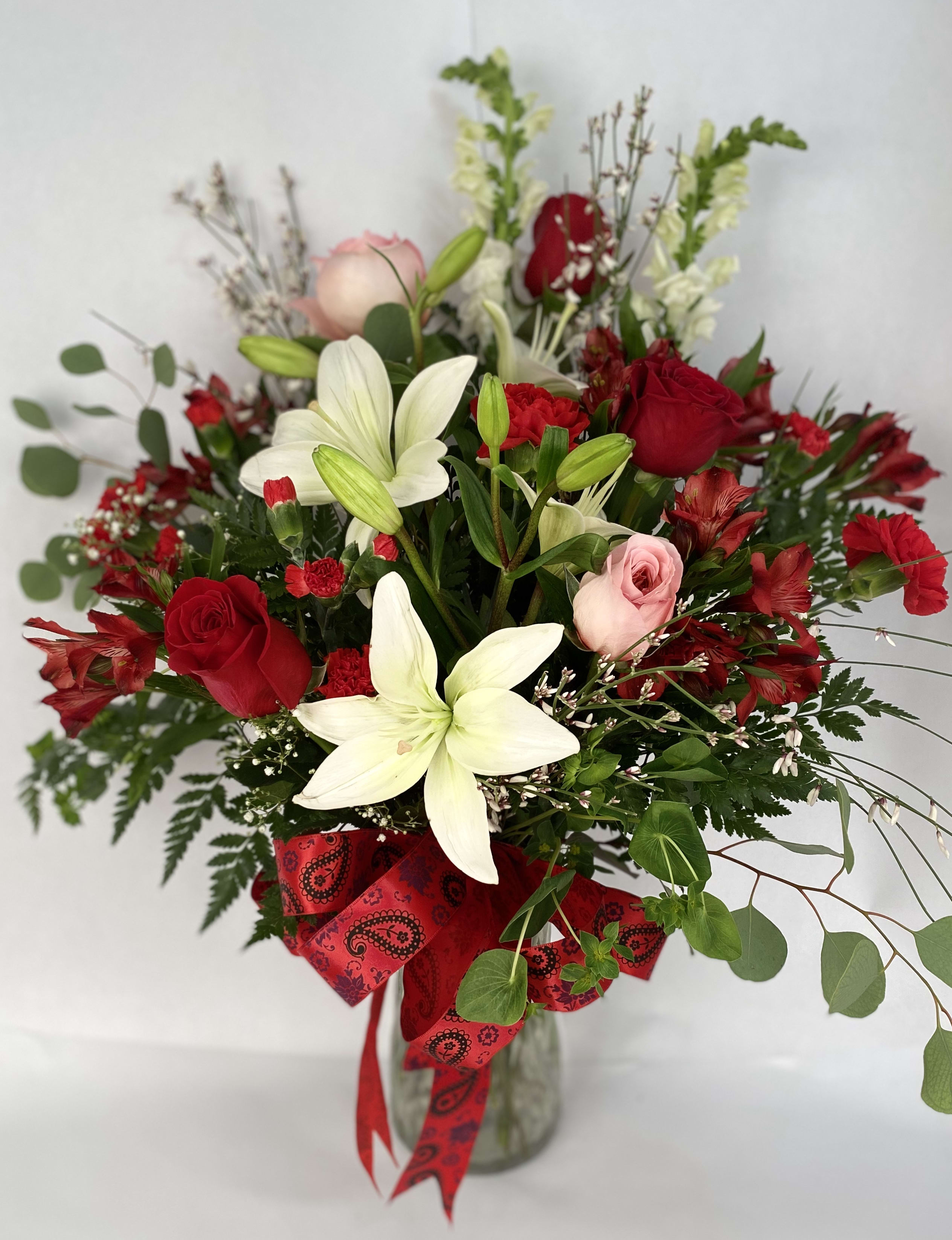 Be Mine Bouquet by Barb's Flowers Be Mine Bouquet by Barb's Flowers - A large clear vase filled with White Asiatic Lilies, Red Roses, Red Carnations, Alstromeria, Red Mini Carnations, Pink Garden Roses, Snapdragons, Fillers and amazing Greenery. "Let her know how much she is wanted"
