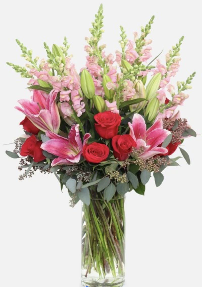 Romantic. - This dazzling arrangement of elegant red roses, stargazer lilies, and pink snapdragons is sure to impress!(flowers of the season)