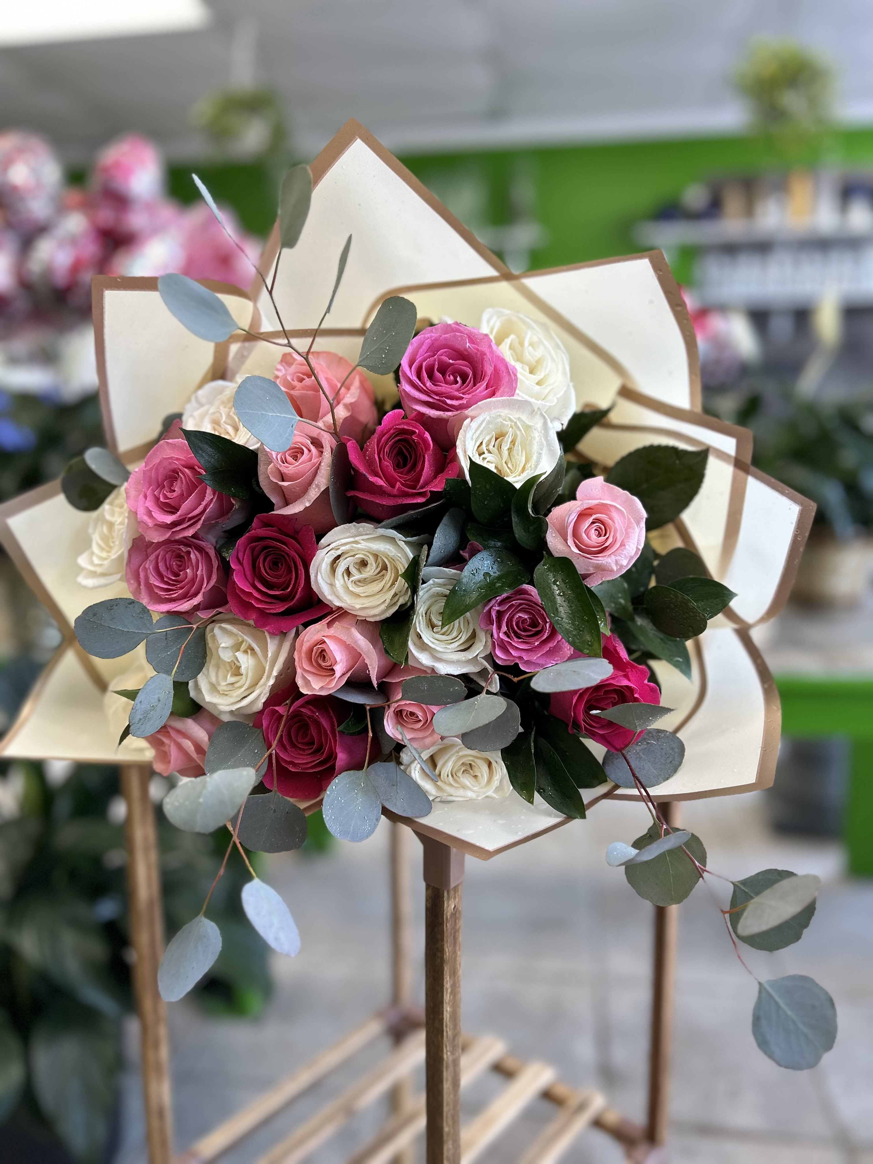 24 Pink roses  - Is there anything more romantic than a stylish roses bouquet with multi-colored roses? Set apart from the traditional single-color rose bouquet, this stylish color combination of hot pink, pink, and white bouquet
