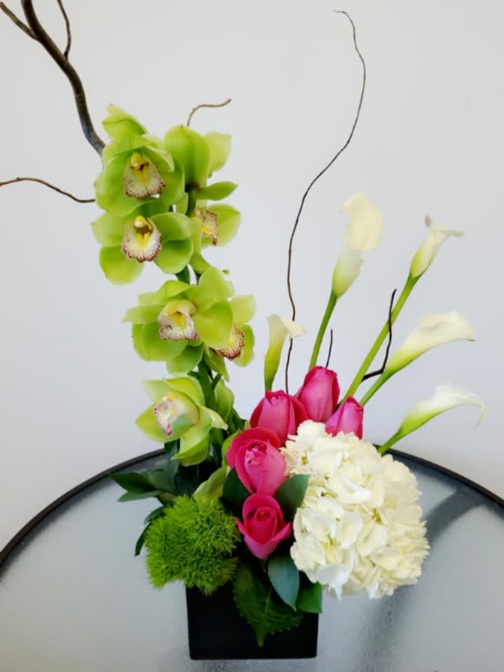 Inspired by you Inspired by you - Beautiful arrangement consisting of cymbidium calla lilies hydrangeas and pink roses Request one day in advance Flowers and similar colors