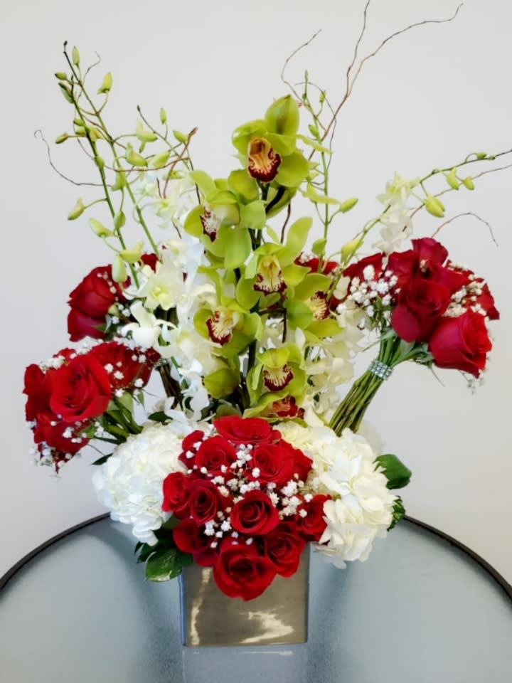 This is Love - Incredible and impressive floral arrangement consisting of five bouquet of 30 red roses, orchids and hydrangeas. All the love in one arrangement  Request one day in advance Flowers and similar colors
