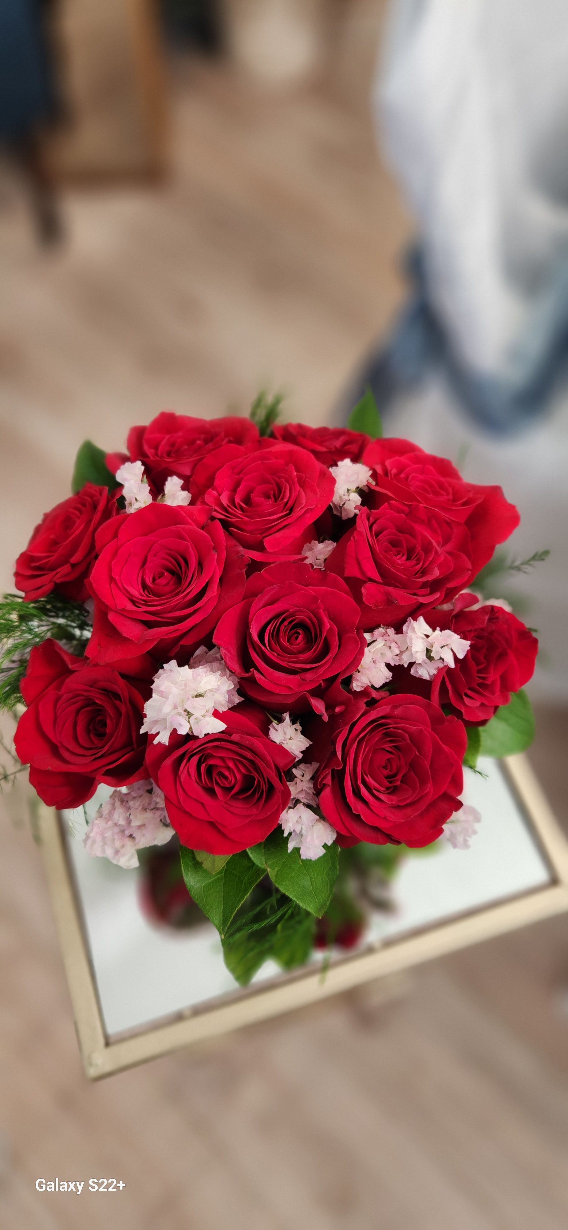 Ruby Delight - A beautifully designed dozen of red roses in a red cube container with pink statice and seeded eucalyptus. 