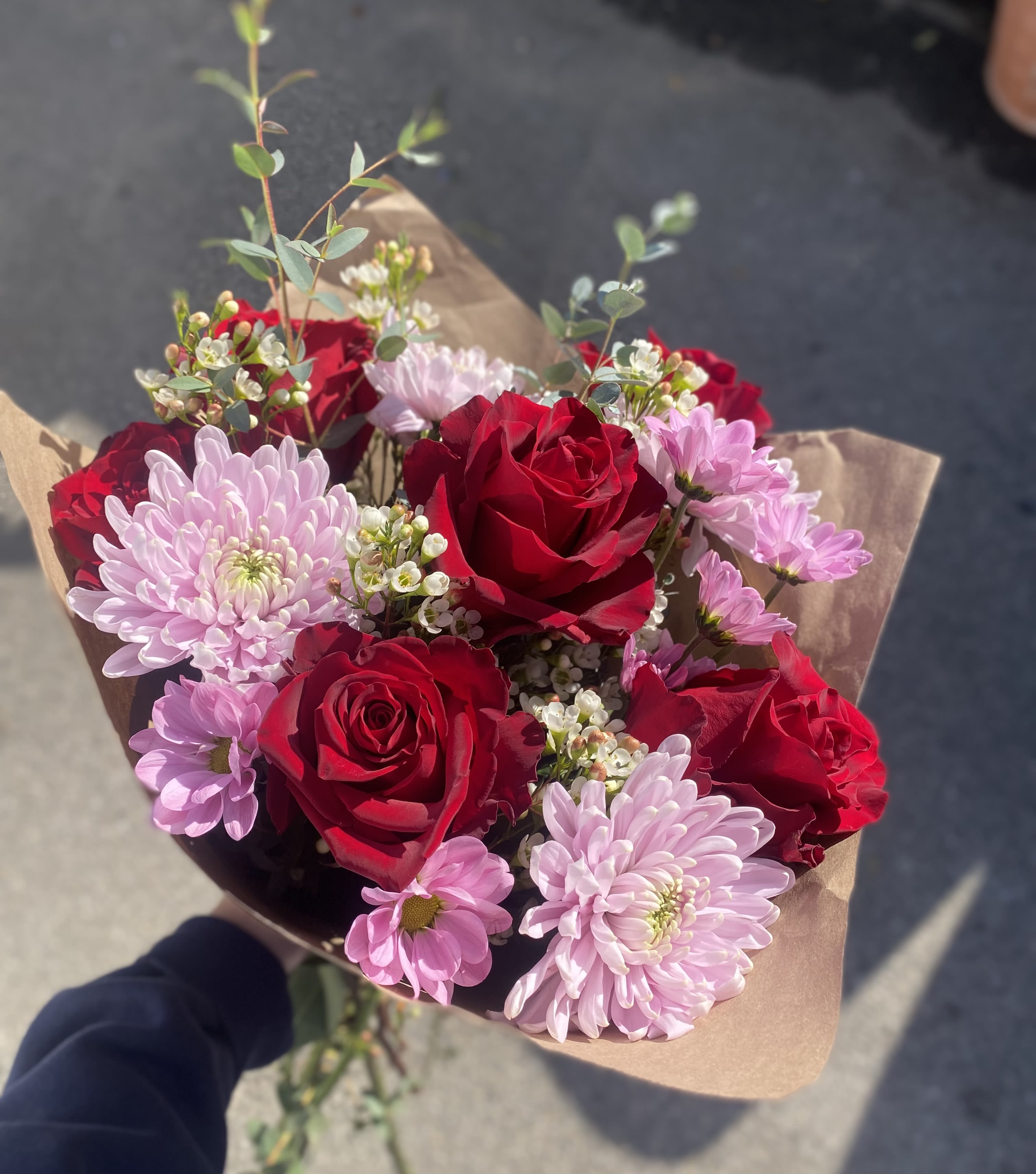 Lovestruck Bouquet Lovestruck Bouquet - A vibrant bouquet of red roses, chrysanthemums, fresh eucalyptus, adorned with small filler flowers.