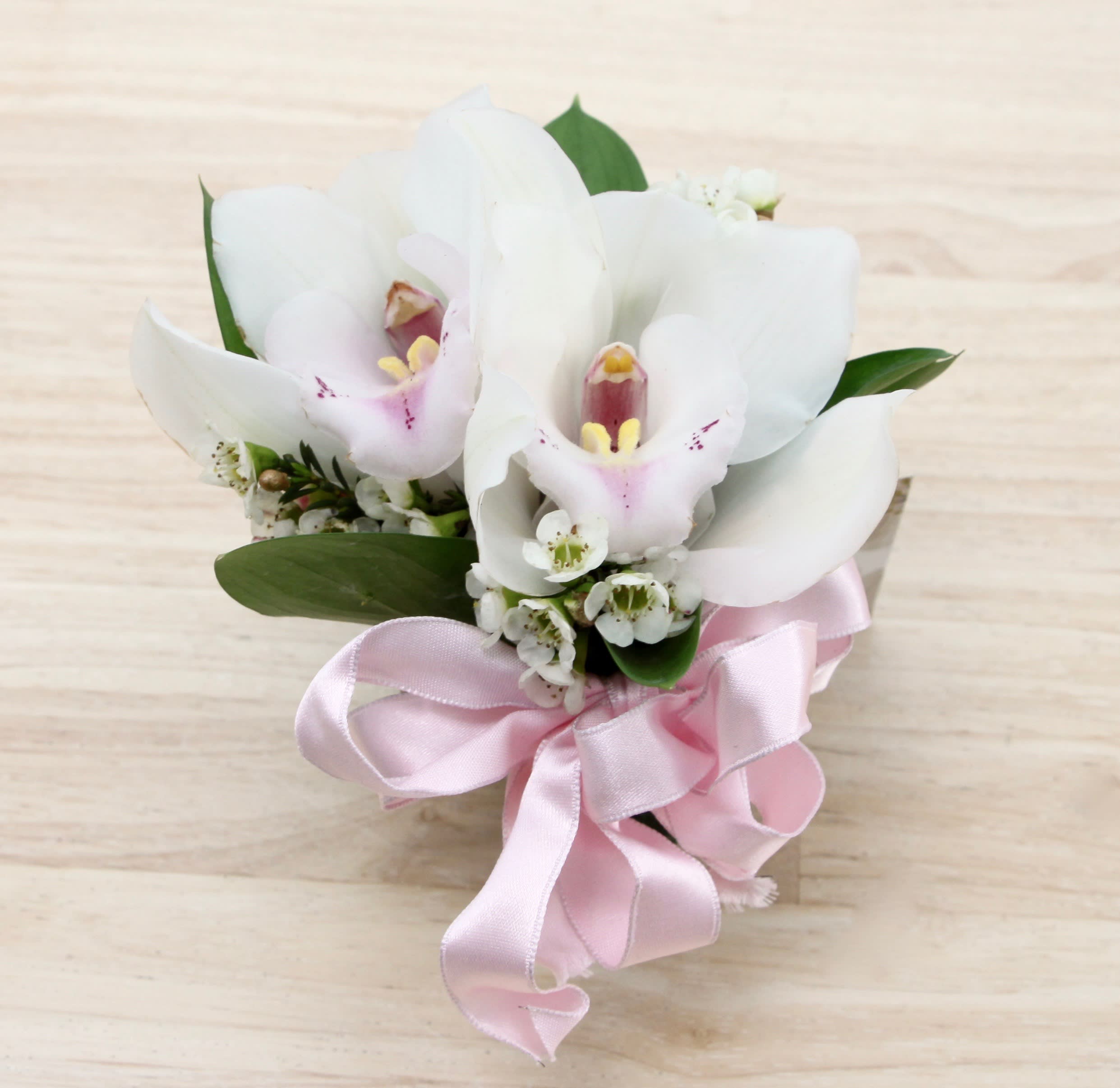 Orchid or Rose Corsage - My Glendale Florist - Orchid or rose corsages include seasonal greens, and a ribbon in the color of your choice. Please specify what colors you would like for flowers in the special instructions and we'll confirm the order once placed.   If you are interested in a boutonniere or corsage for any occasion, please order at least 24 hours in advance.  